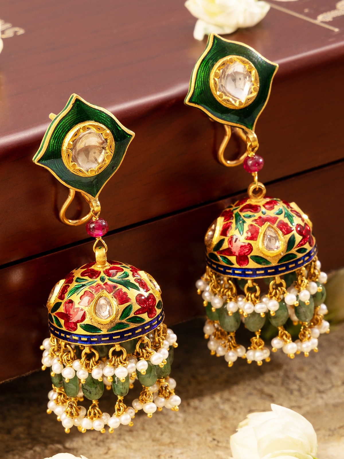Side view of Meenakari 22 Karat Gold Jhumkas emphasizing the jhumkas' design and detailed craftsmanship