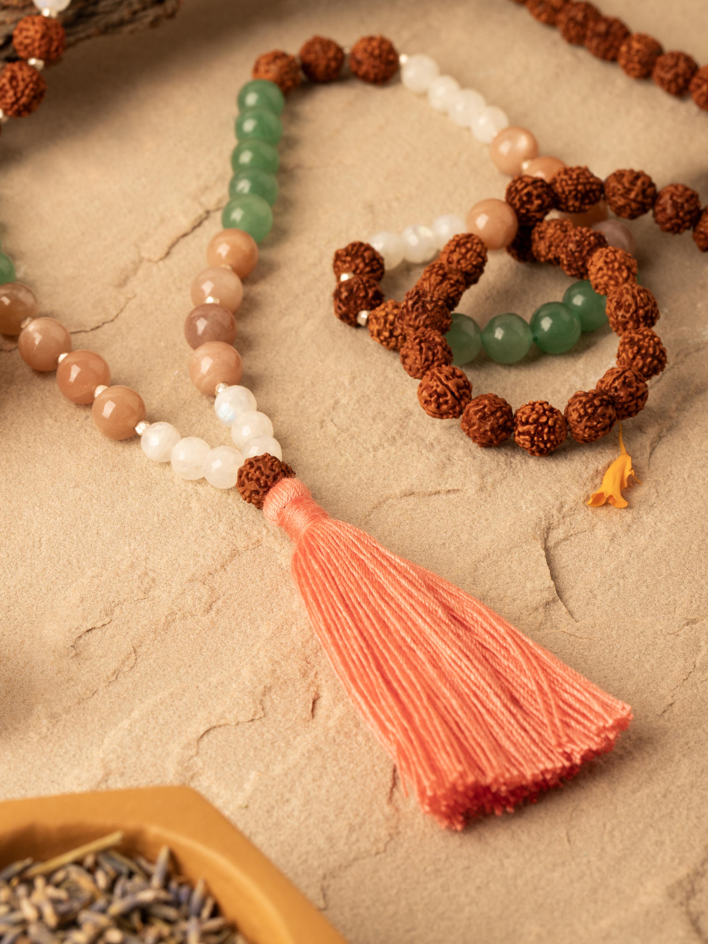 Side view of Peach & White Moonstone, Green Aventurine & Rudraksha Silver Mala displaying the depth and bead size of the mala.