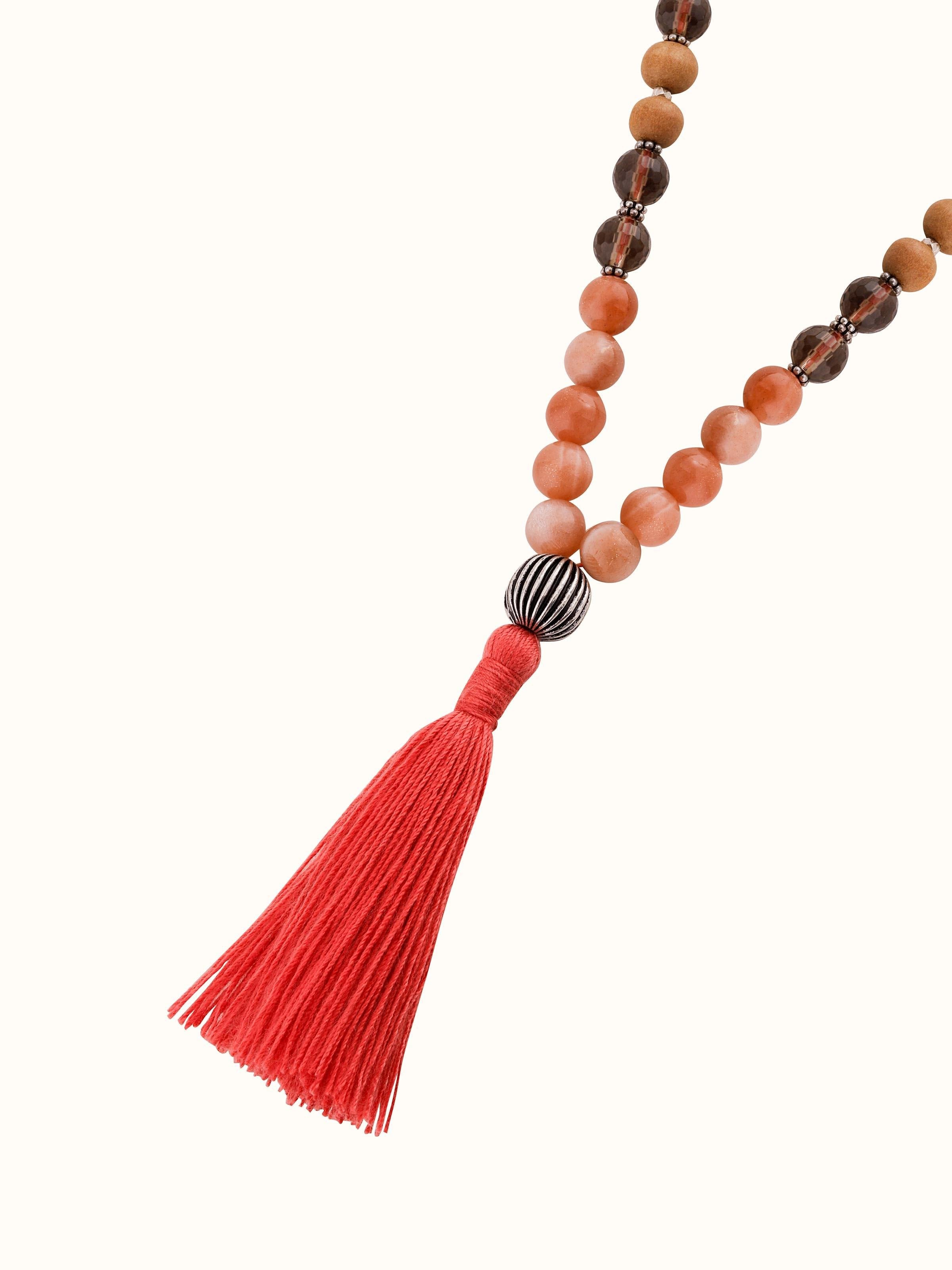 Angled view of Smoky Quartz, Red Onyx, Peach Moonstone & Rudraksha Silver Mala emphasizing the unique bead shapes and colors