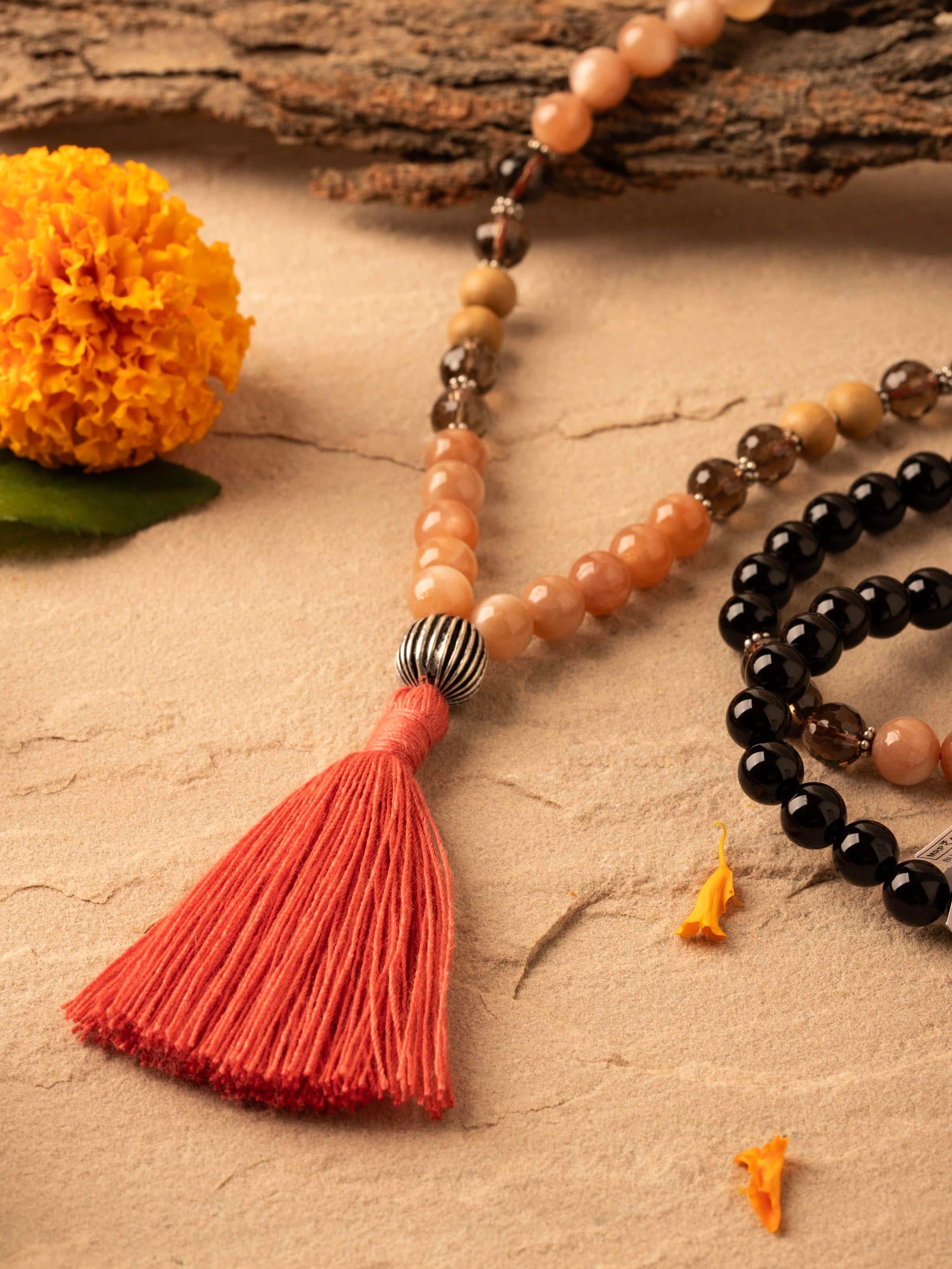 Detailed view of Smoky Quartz, Red Onyx, Peach Moonstone & Rudraksha Silver Mala focusing on the texture of the gemstones and rudraksha beads