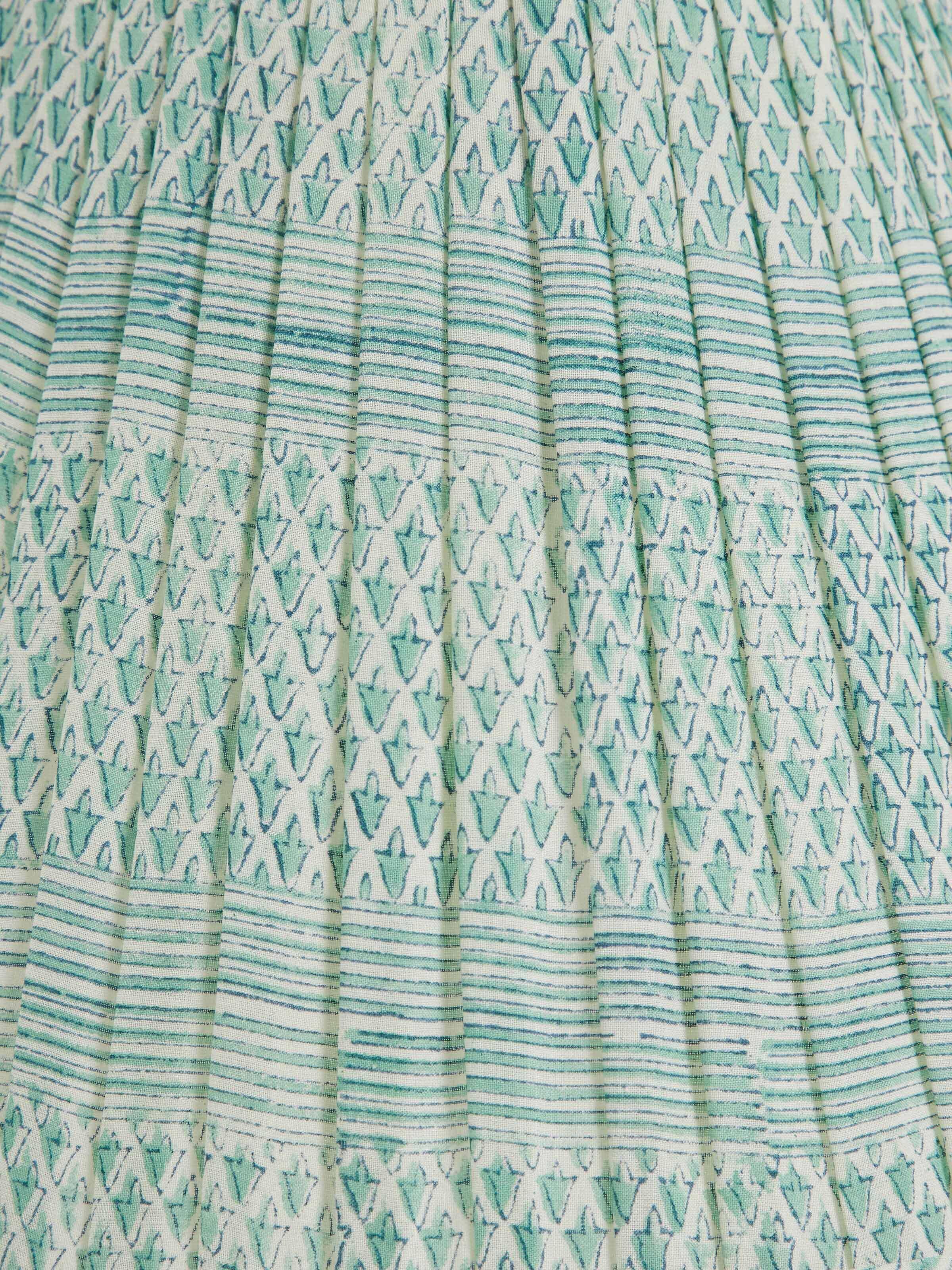 Artistic view of Block-Printed Pleated Cotton Lampshade in Turquoise Color, highlighting its texture and color contrast
