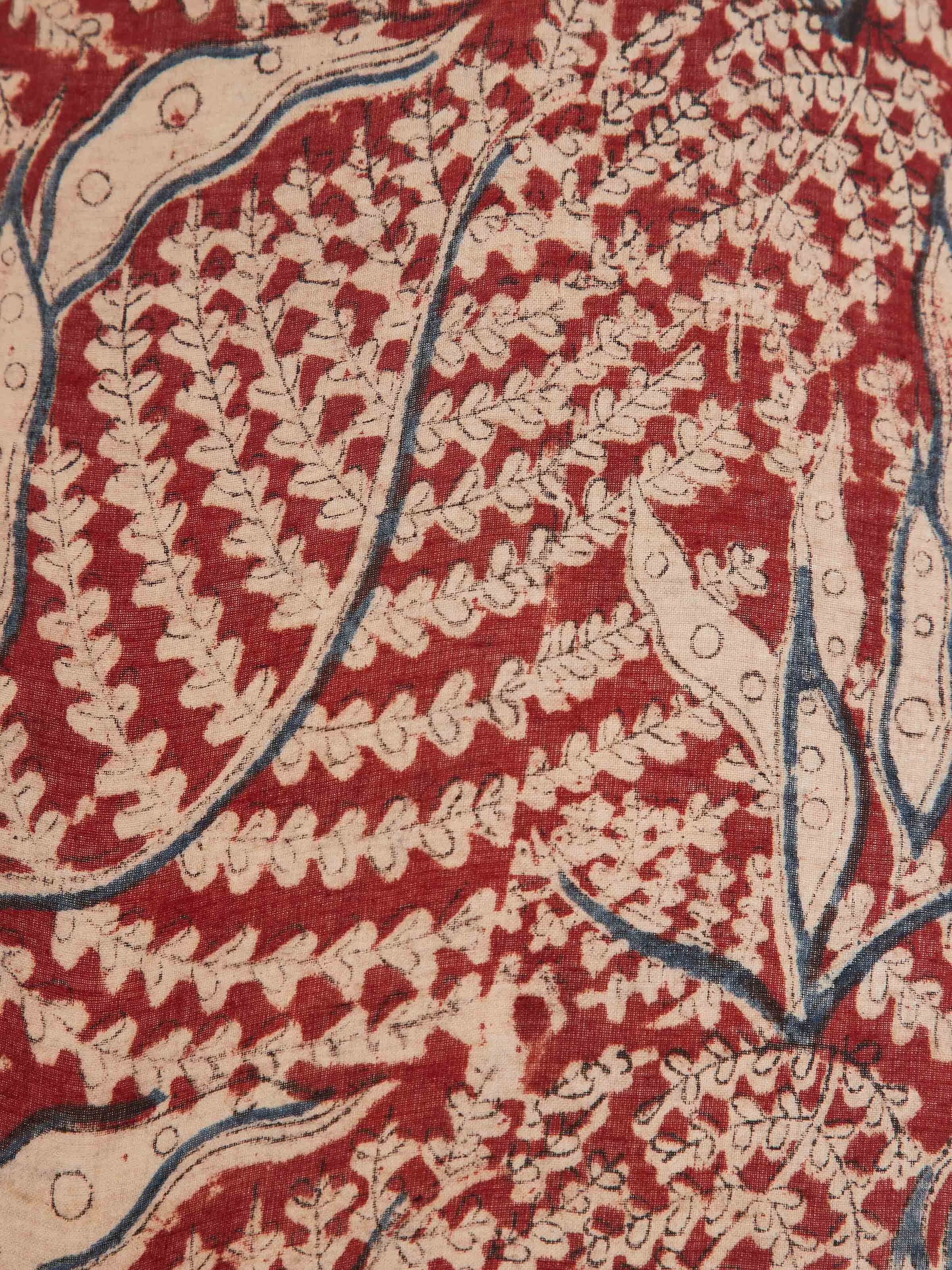 Close-up view of Kalamkari block-printed cotton lampshade in red color, focusing on the fine details of the block prints.