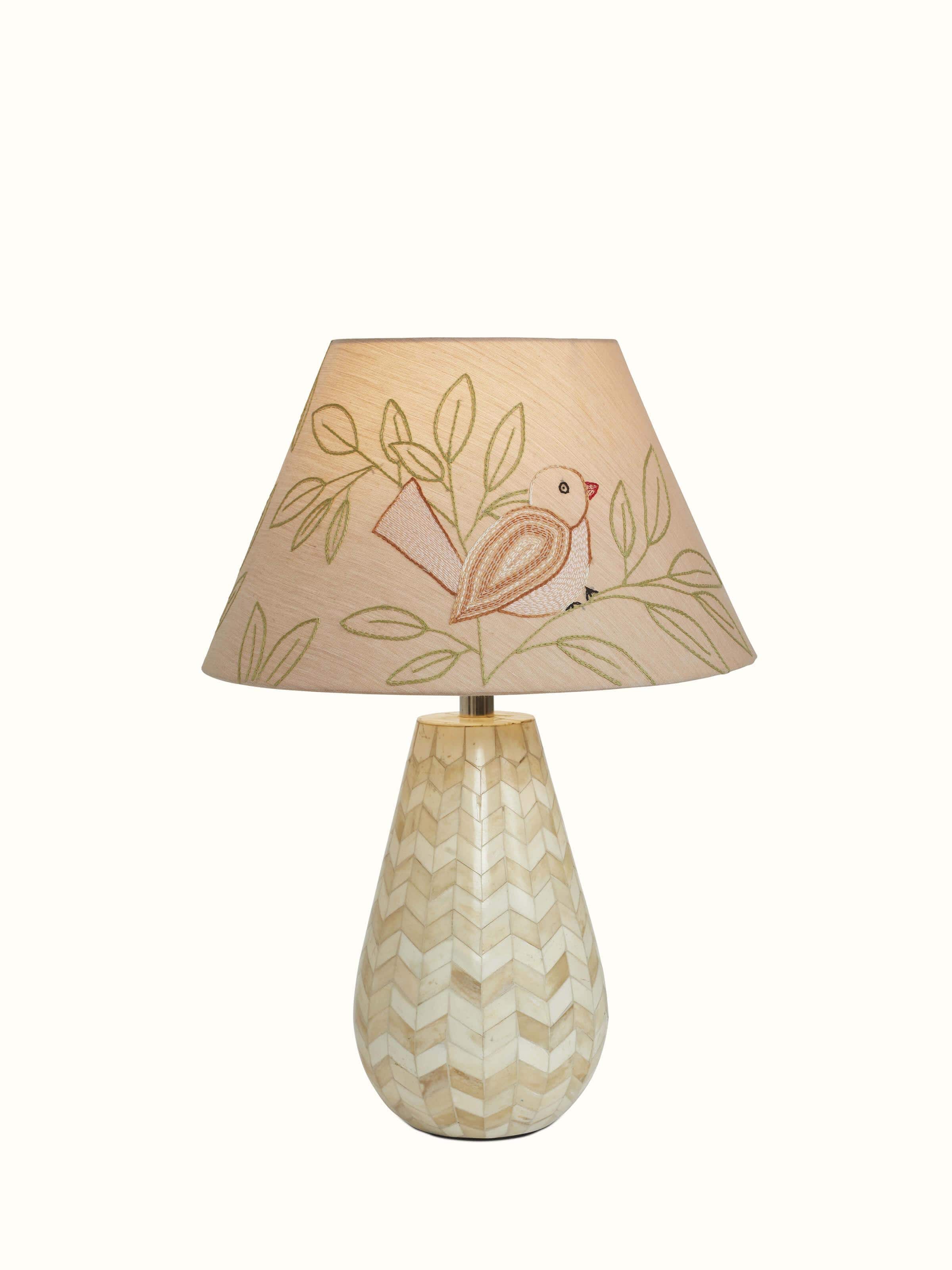 Angled view of Sujani embroidered cotton lampshade in large beige color highlighting the fine stitching and design