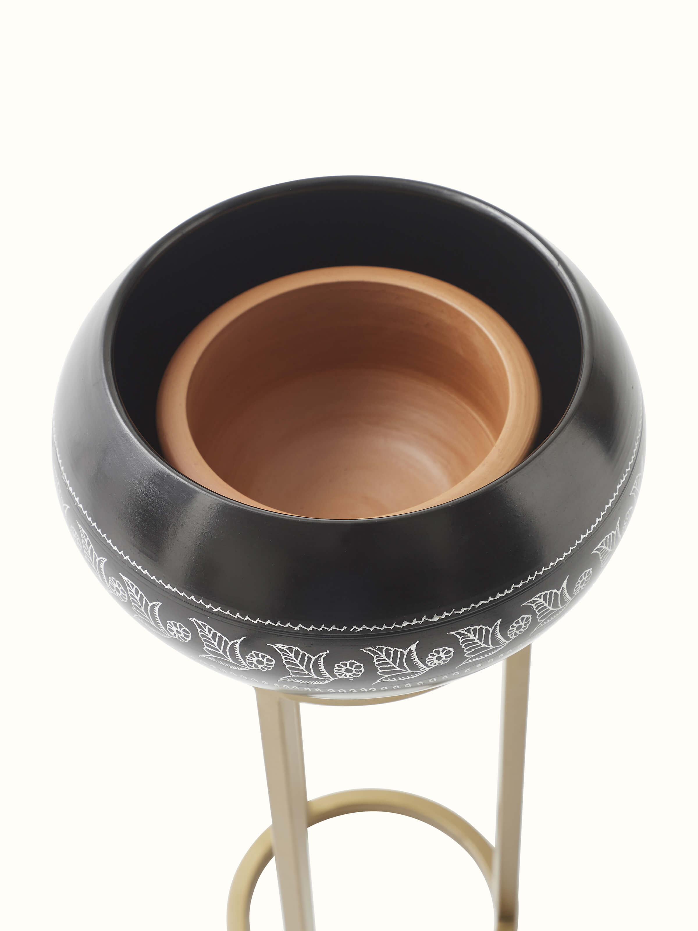 Close-up of black pottery ceramic planter showing detailed craftsmanship and surface texture