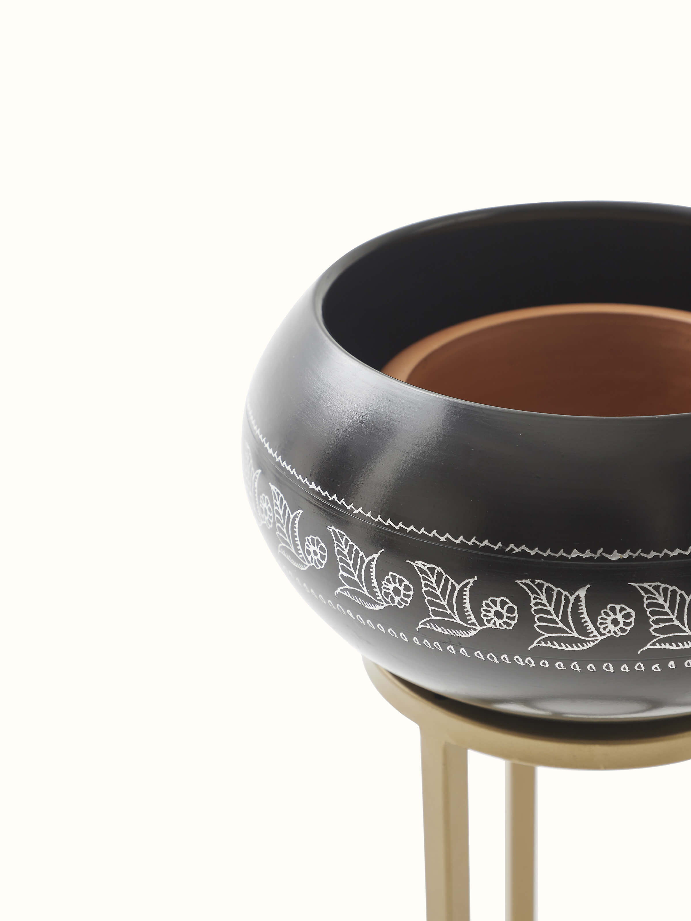 Side vies of black pottery ceramic planter displaying its unique shape and texture