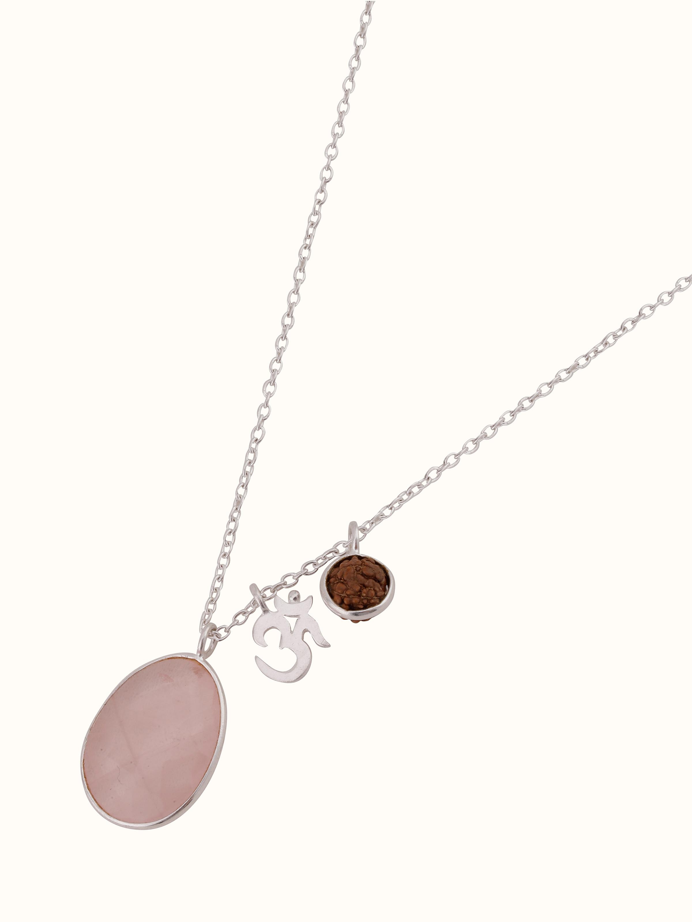 Artistic shot of Rose Quartz, Om Silver Charm & Rudraksha Sterling Silver Necklace, focusing on the detailed texture and craftsmanship.