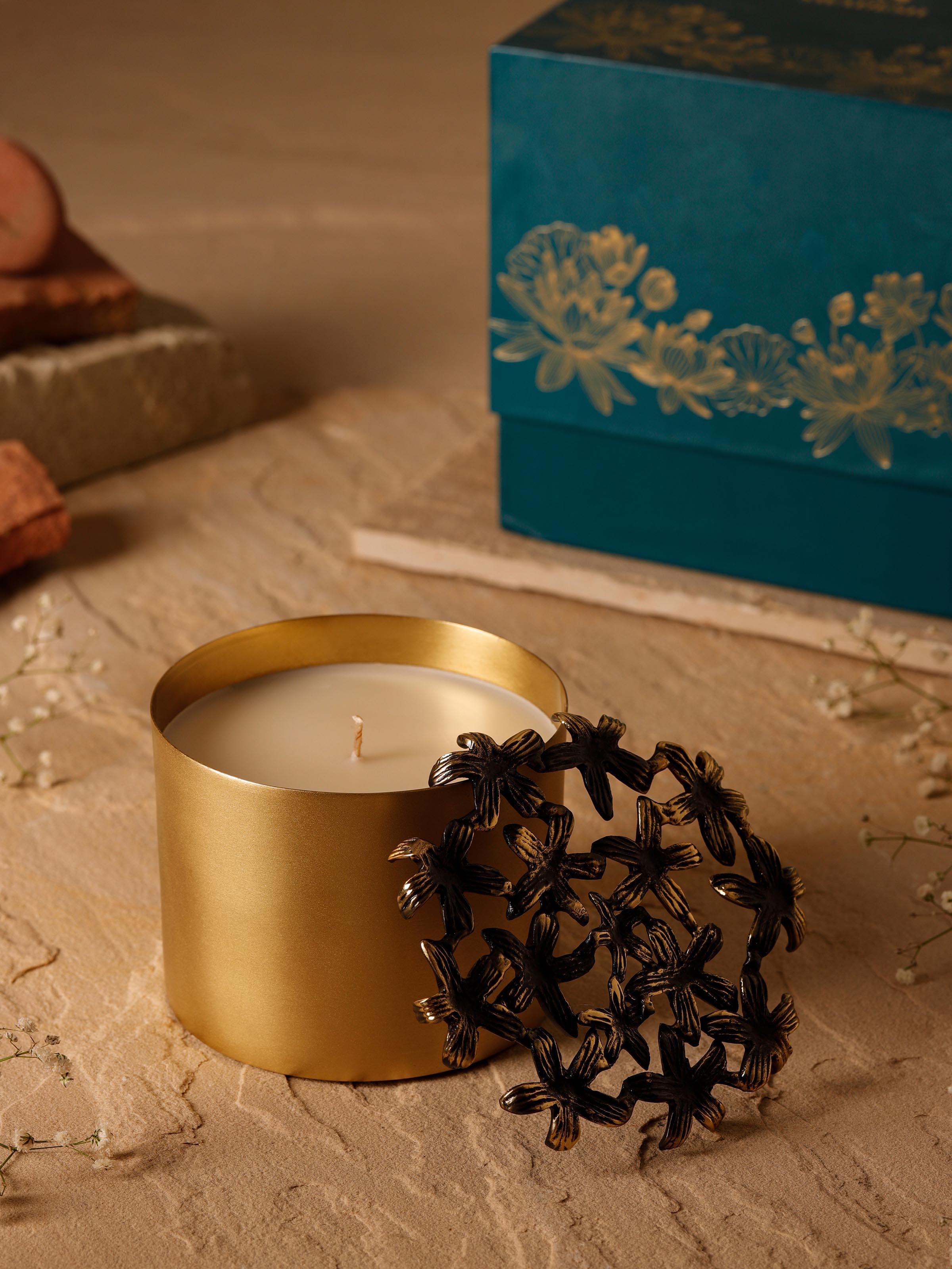 Side view of Jasmine Brass Candle highlighting the intricate detailing and warm glow