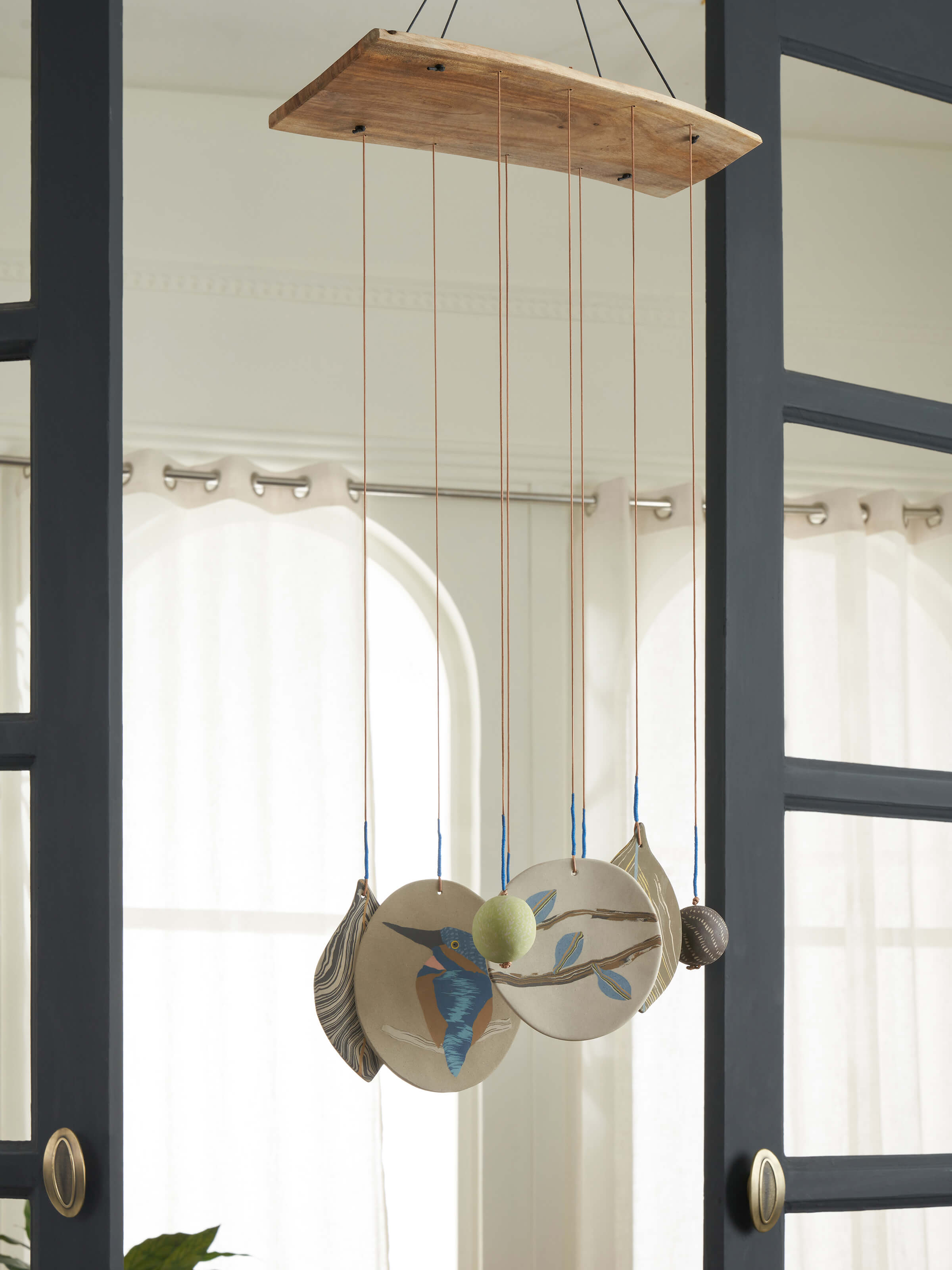 Side view of Whispering ceramicware clay wind chime highlighting intricate detailing