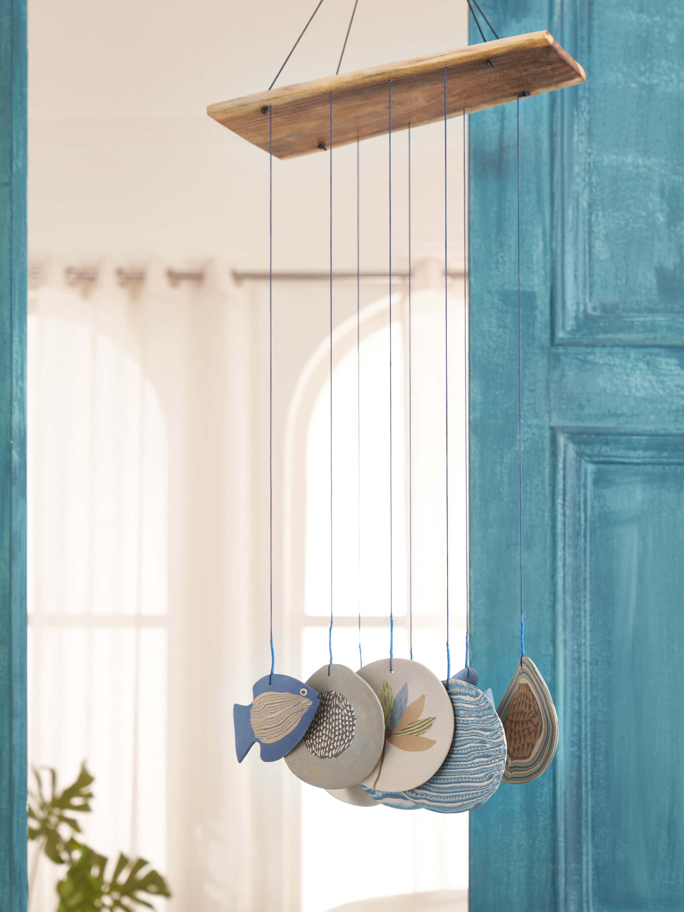 Close-up view of ceramic wind chime, showcasing its intricate details and vibrant colors.