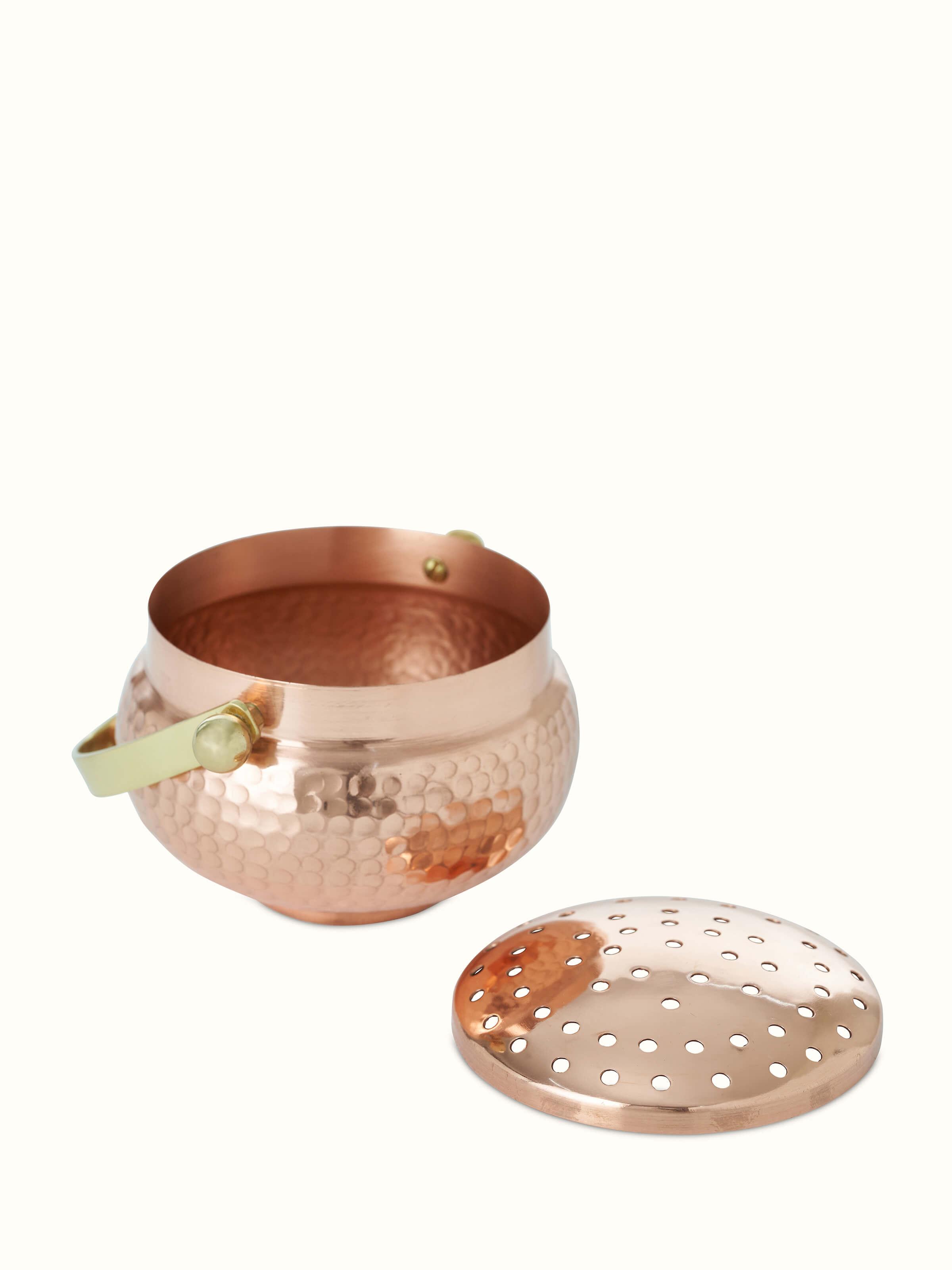 Detailed view of Polished copperware dhuna small