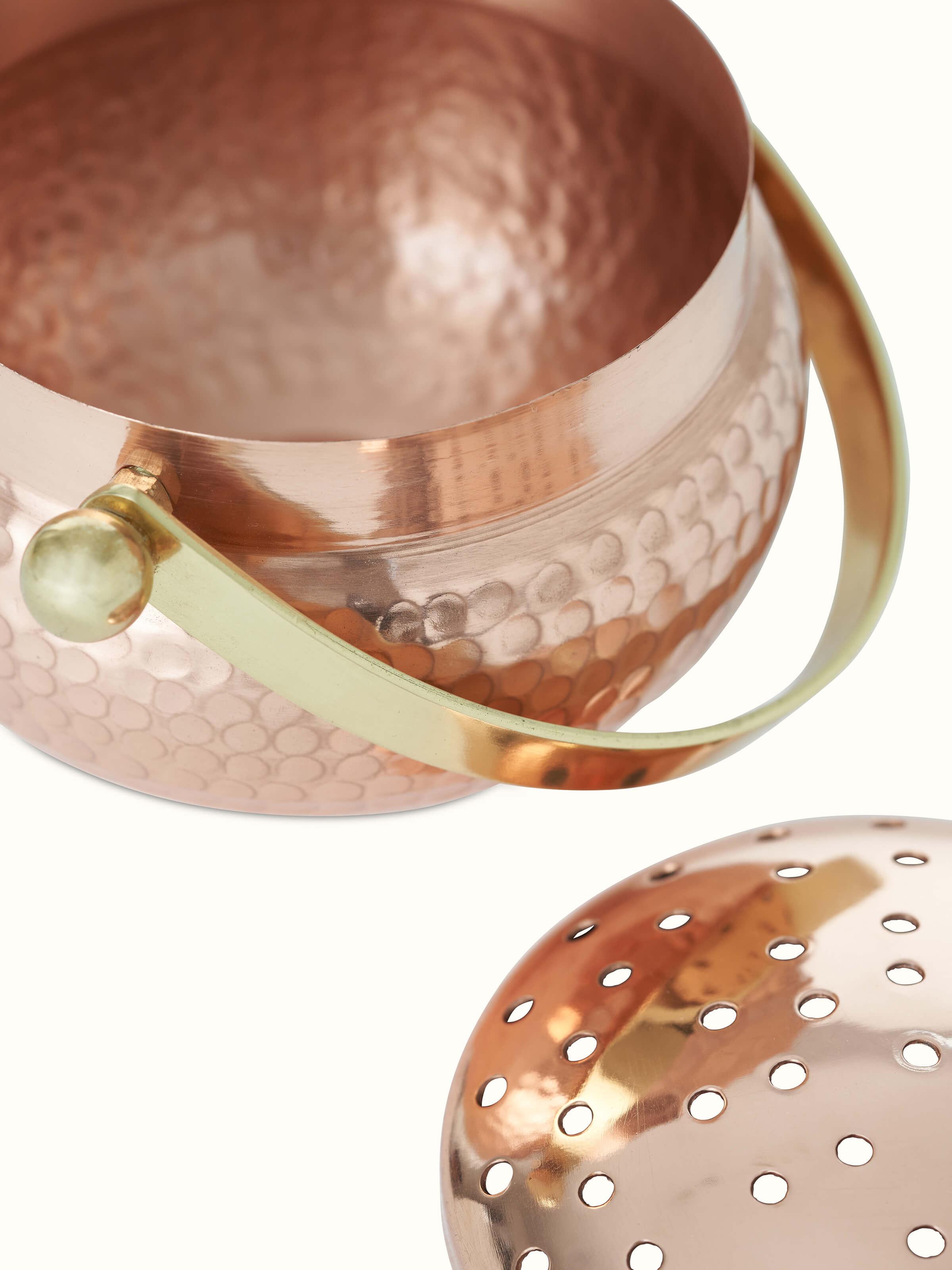 Close-up view of Polished copperware dhuna small