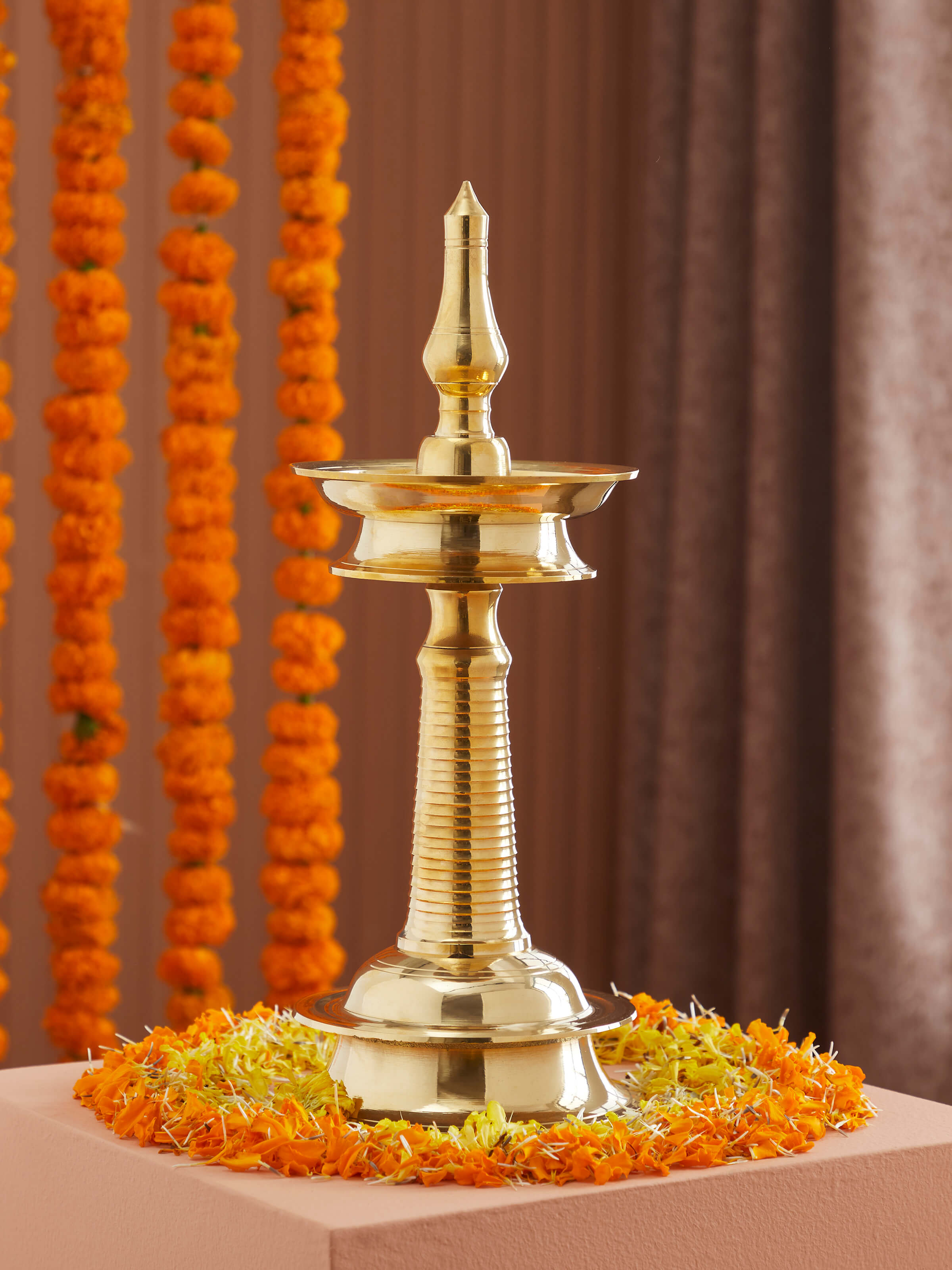 Side view of Brass Kuthu Vilakku Stand Diya, highlighting its elegant curves and craftsmanship