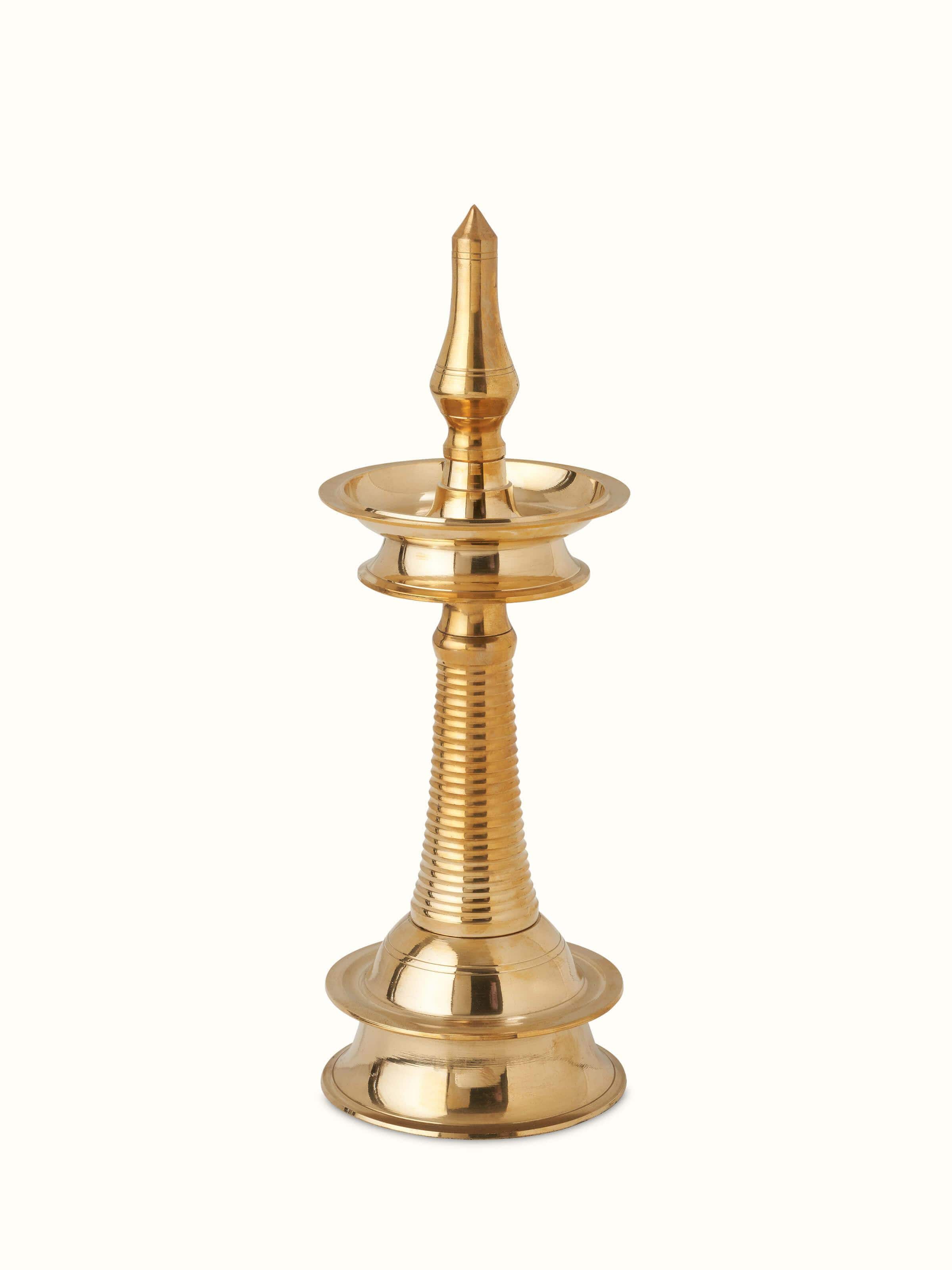 Brass kuthu vilakku stand diya with intricate detailing, showcasing its traditional design and shine.