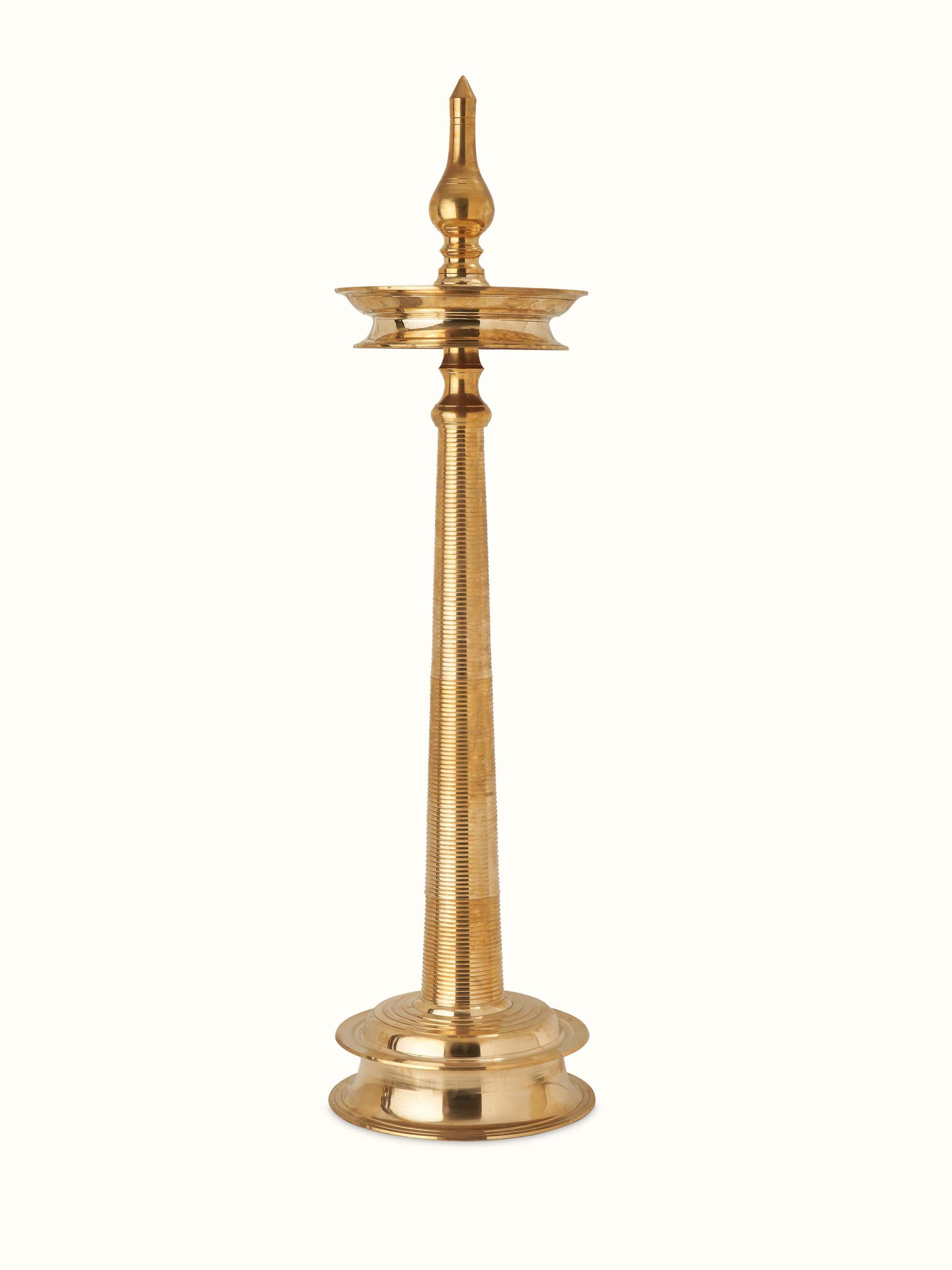Front view of decorative brass samai vilakku stand diya, showcasing the ornate brasswork and design.