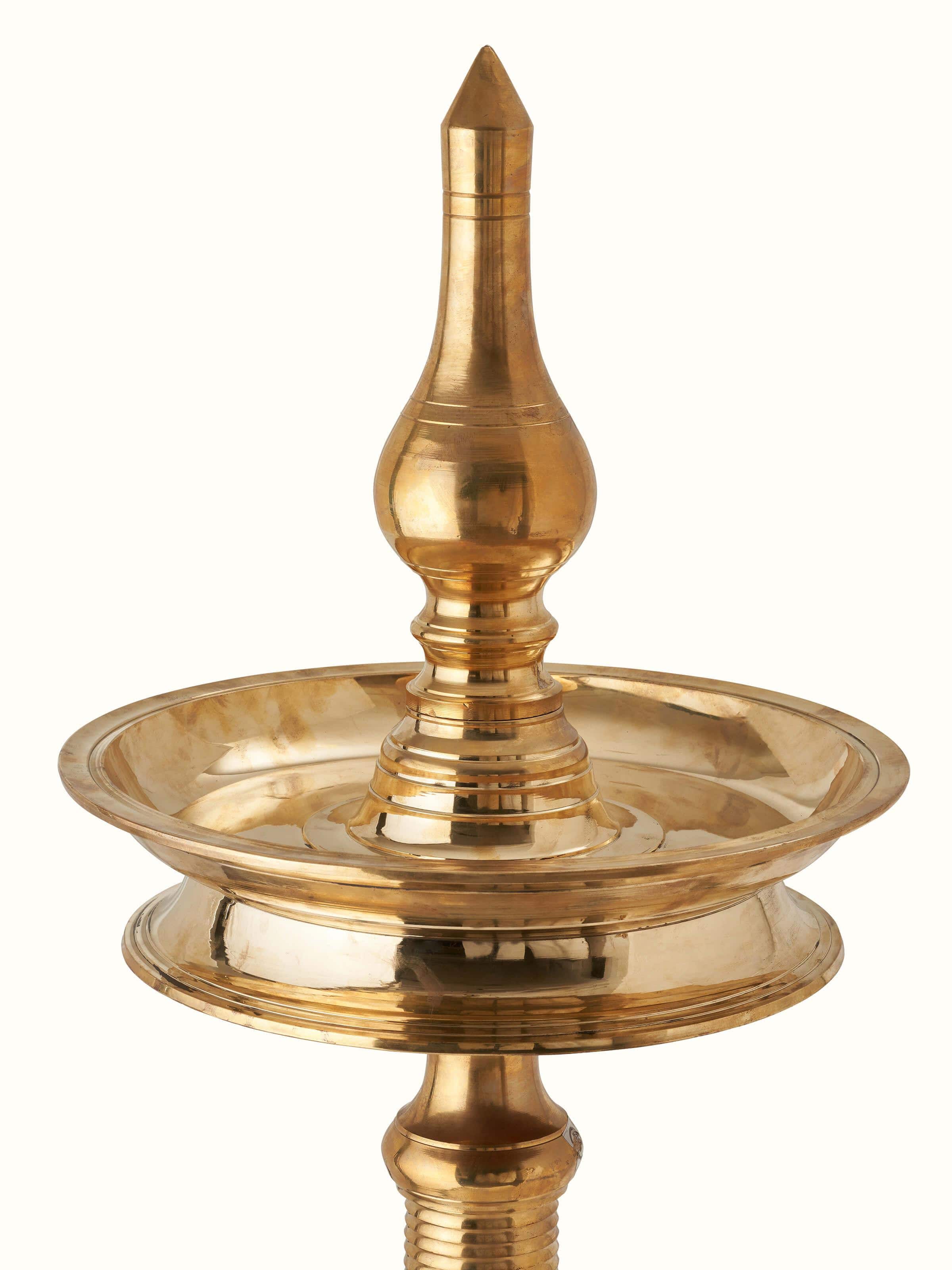 Artistic view of decorative brass samai vilakku stand diya, displaying the elegant brass detailing and design.