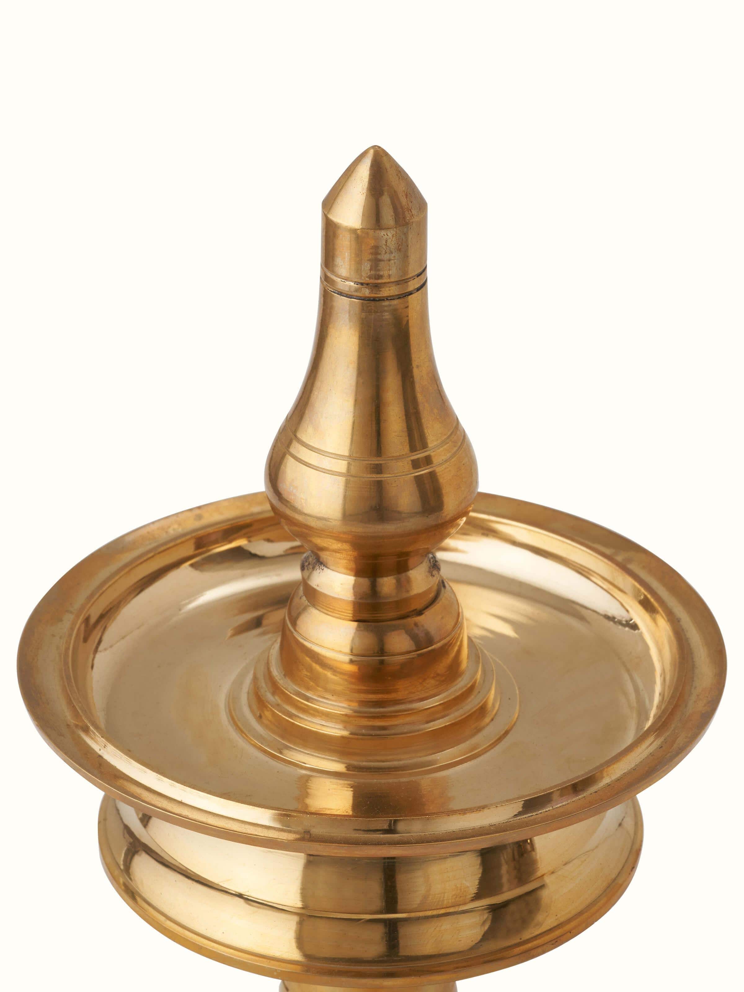 Close-up of Kerala brass samai vilakku detailing its traditional design and fine brass finish
