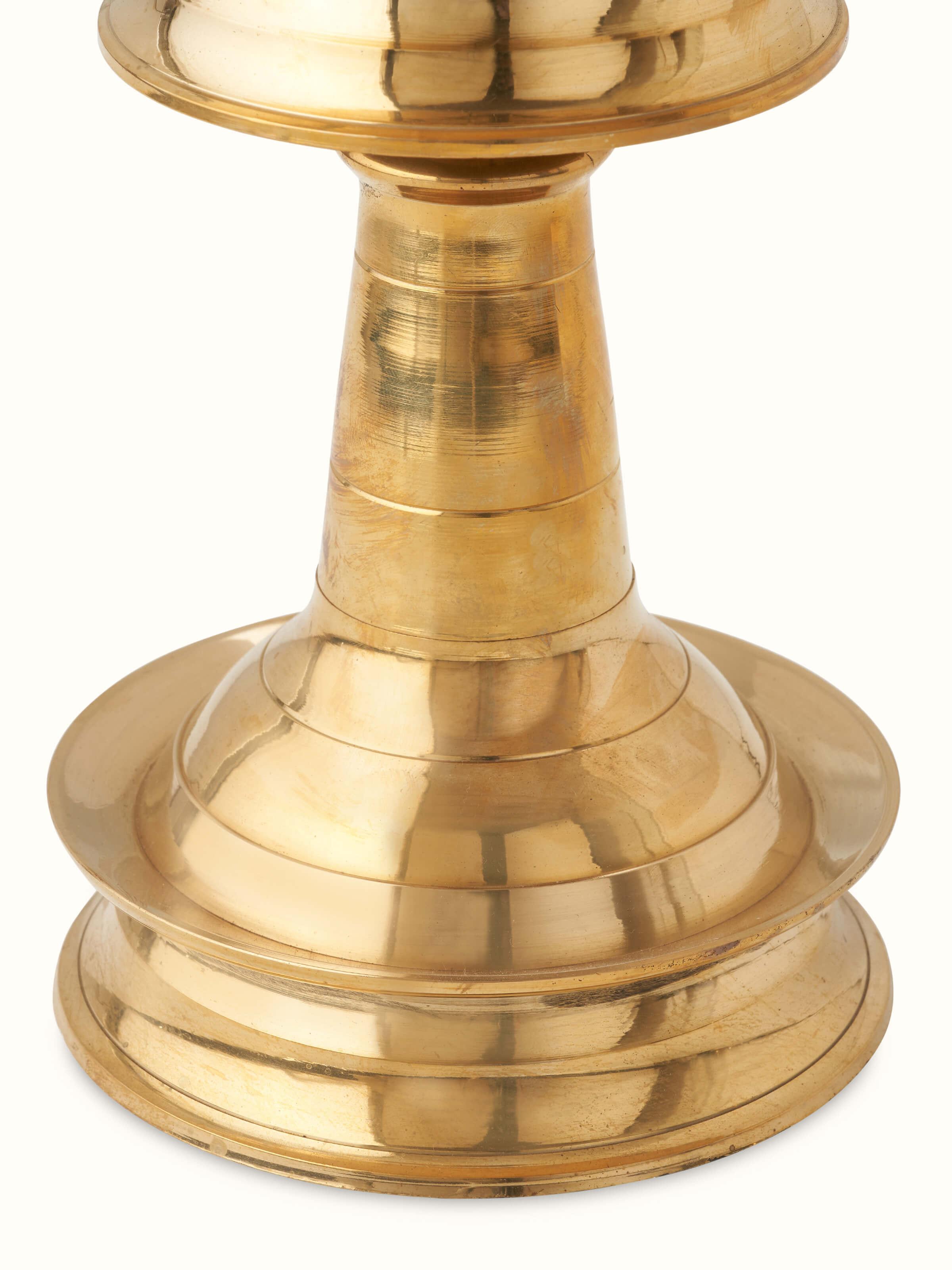 Angle view of Kerala brass samai vilakku showcasing the rich brass texture and intricate design