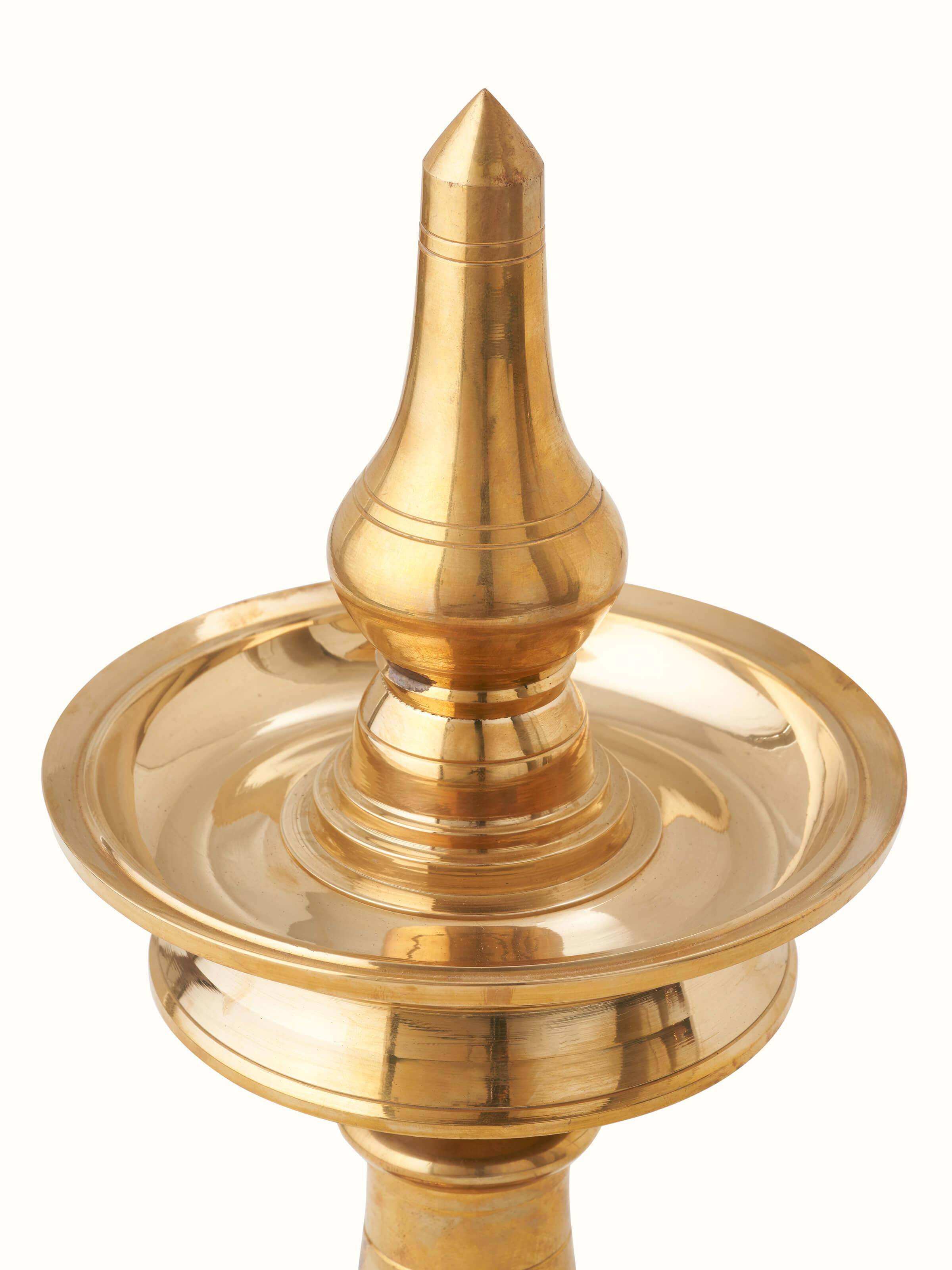 Detailed view of Traditional brass samai vilakku stand diya highlighting the decorative patterns