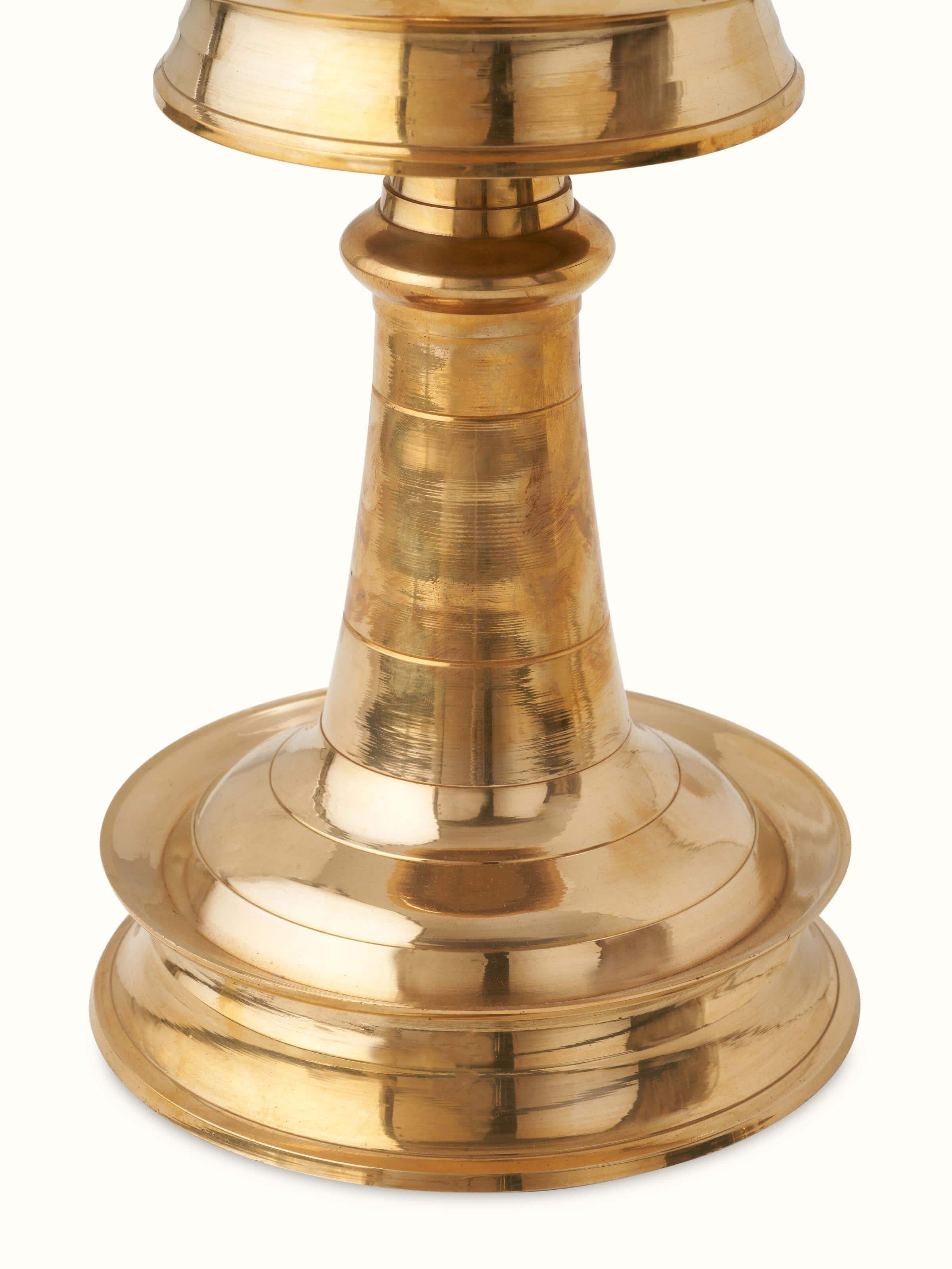Close-up view of Traditional brass samai vilakku stand diya focusing on the intricate details