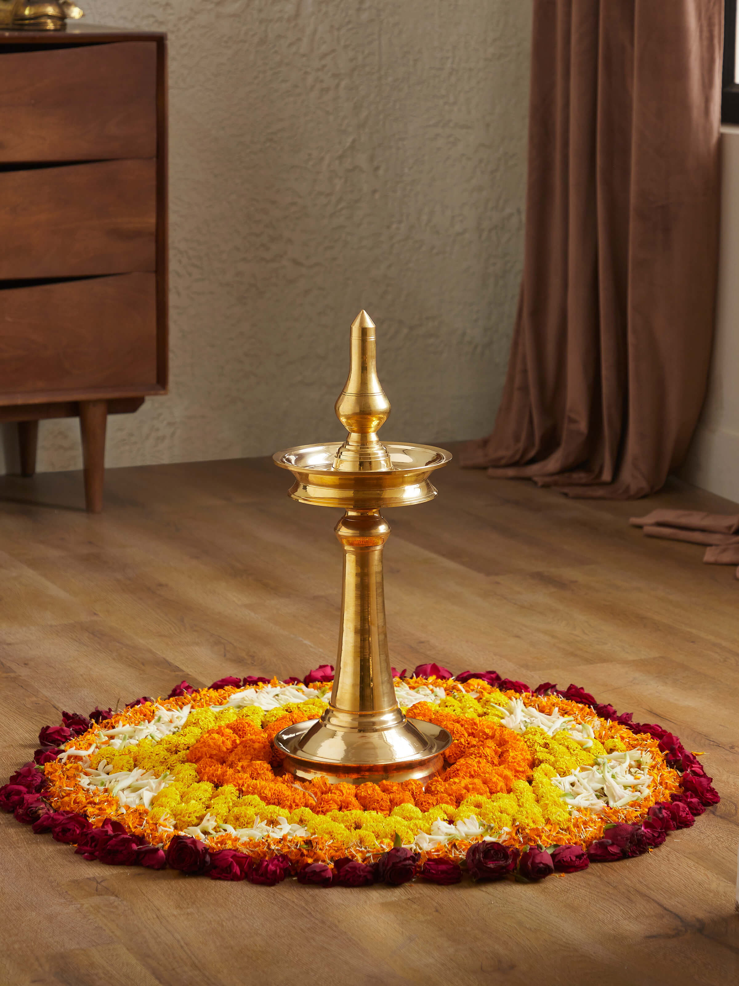 Front view of brass samai vilakku stand diya, highlighting the intricate brass work and traditional style.