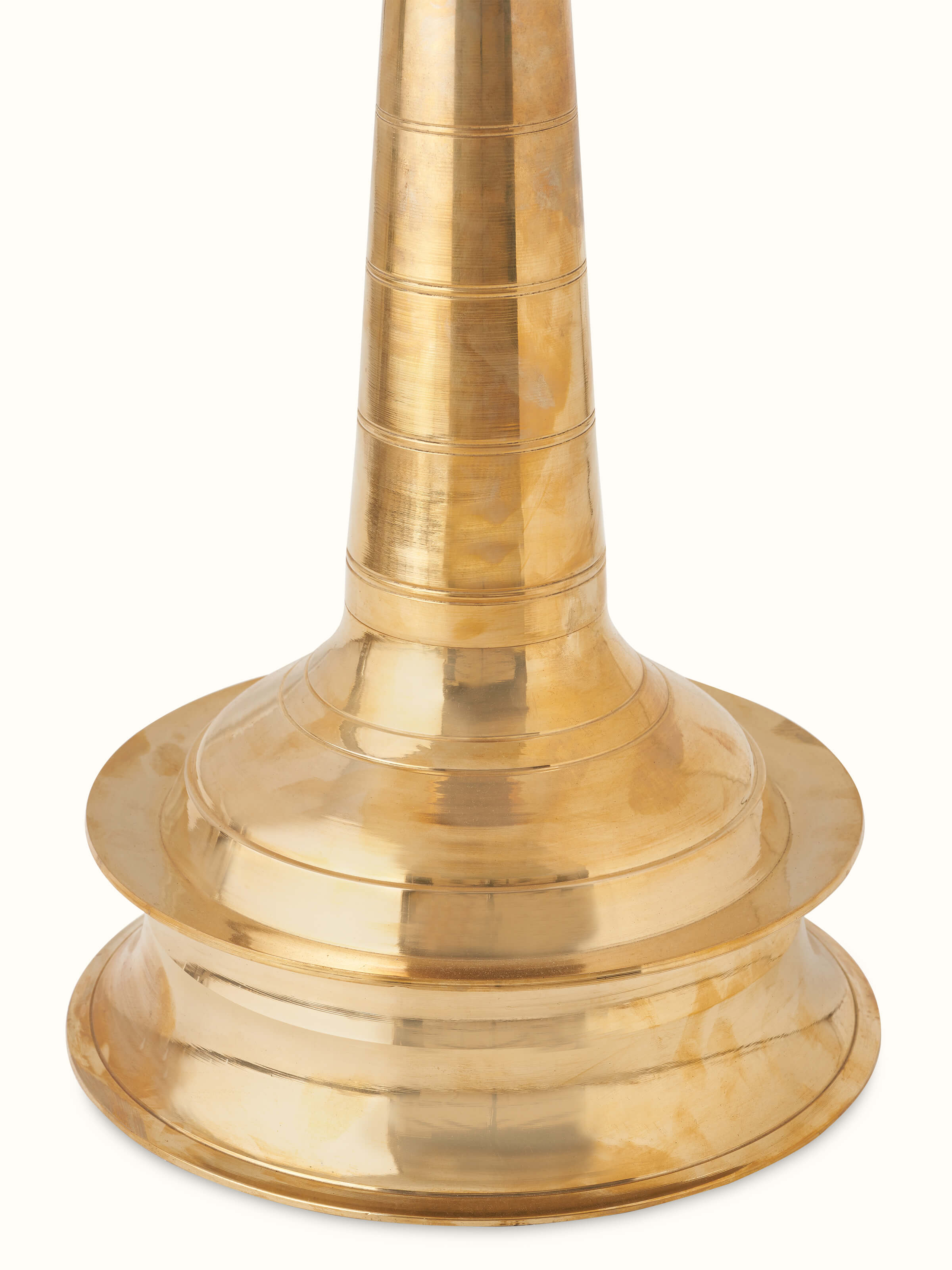 Side view of brass samai vilakku stand diya, emphasizing its detailed brass work and elegant design.