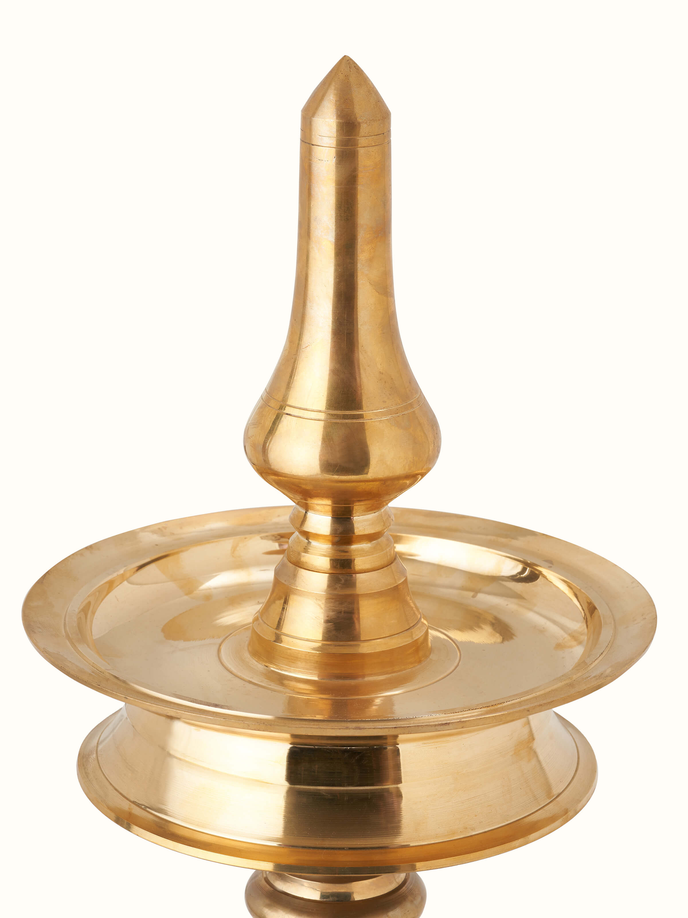 Detailed close-up of brass samai vilakku stand diya, focusing on the ornate design and craftsmanship.