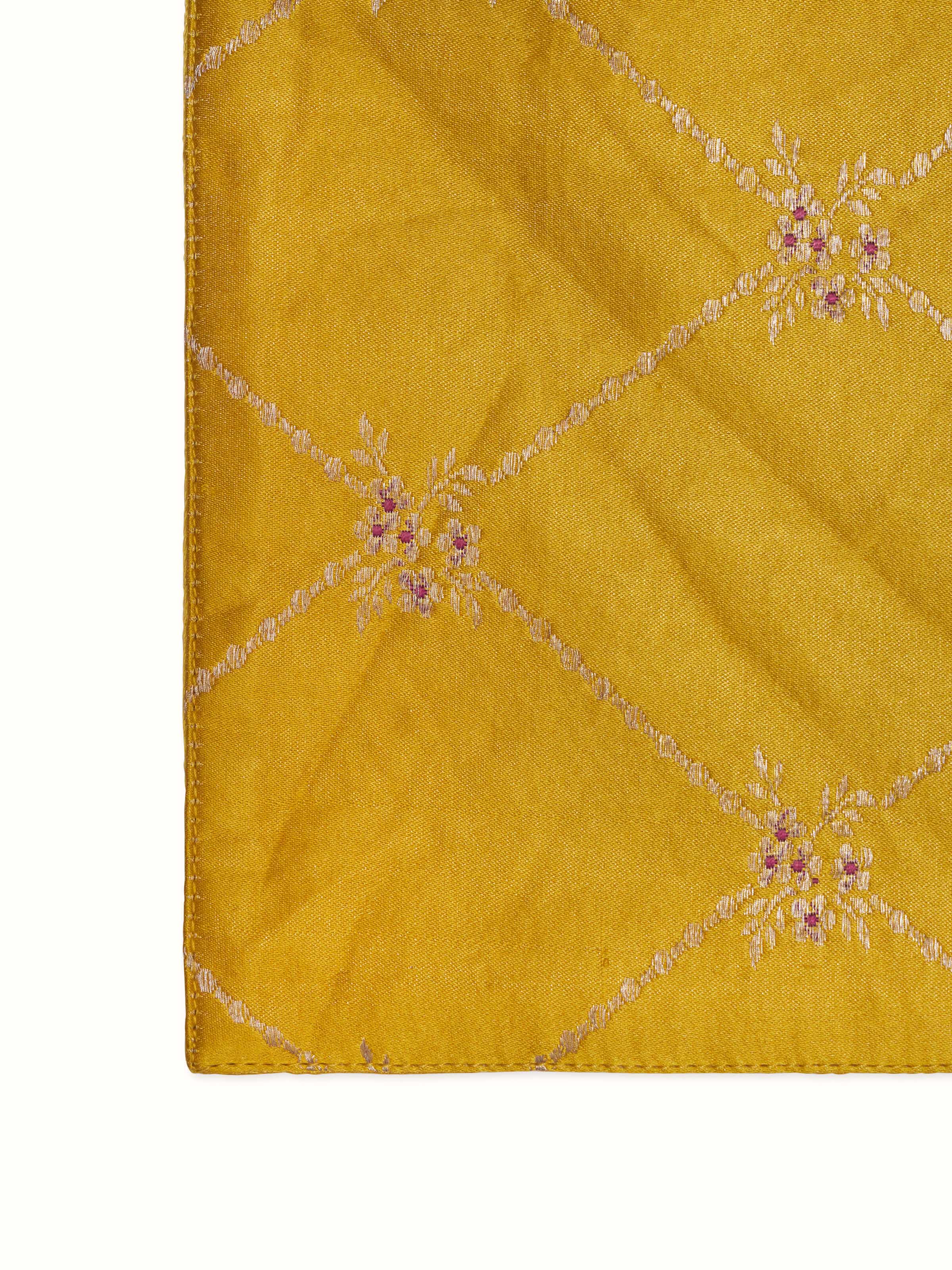 Detail shot highlighting the golden brocade weaving and trellis design on Mandana yellow Banarasi silk table mats