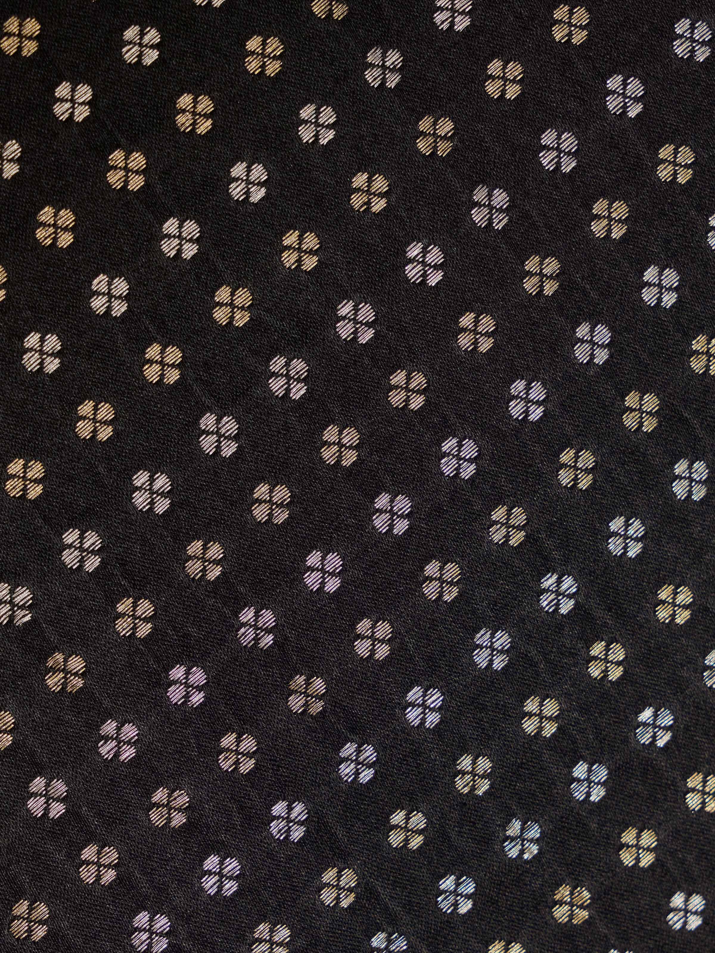 Close-up of Adil Banarasi Table Mat, highlighting rich black silk base with gold brocade accents.