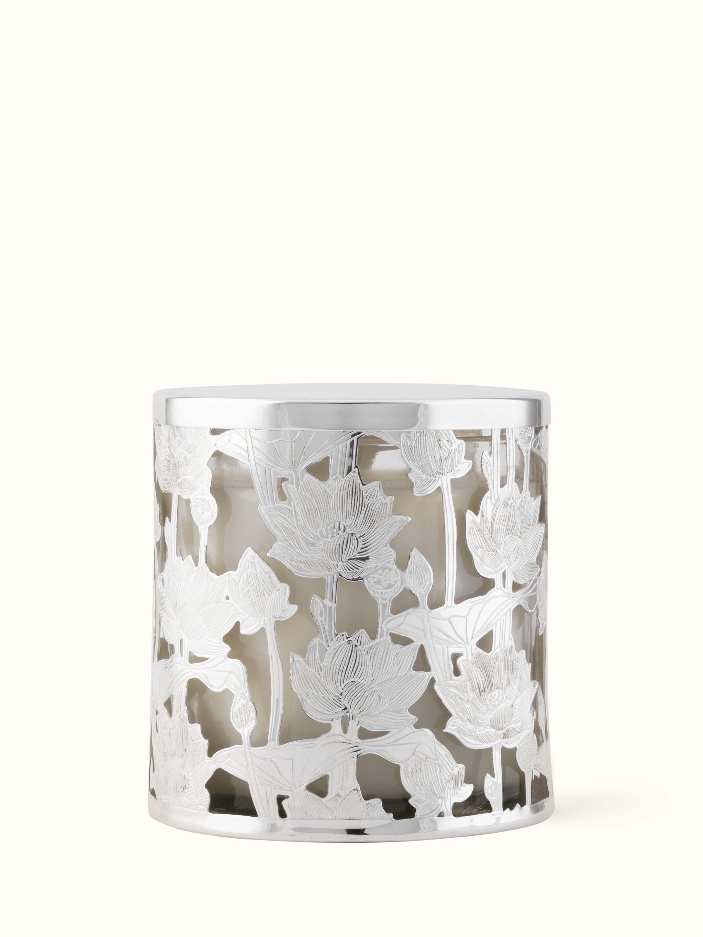 Angled view of silver-plated brass candle holder highlighting elegant design features.