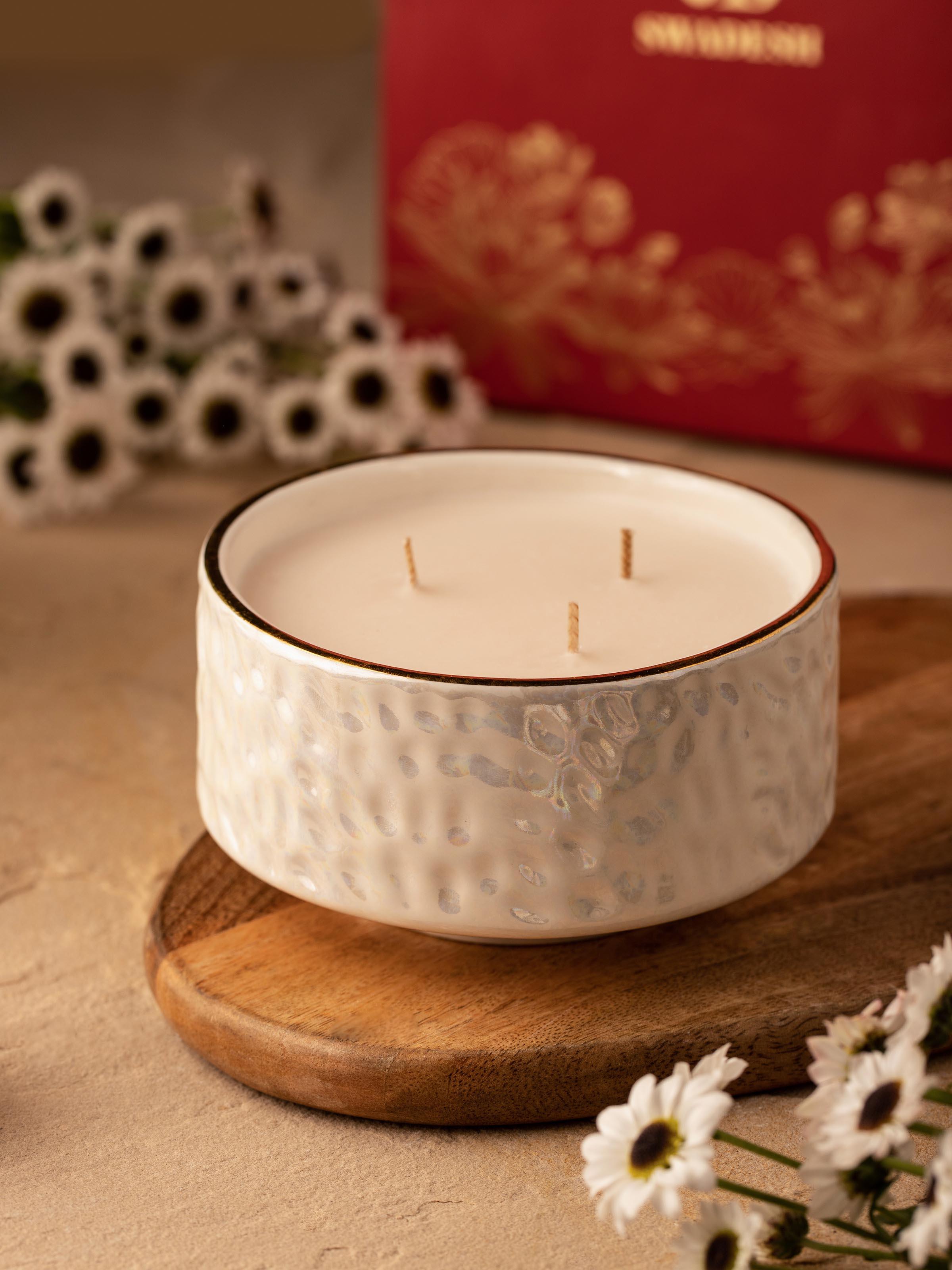 Side view of White Ceramic Candle highlighting the smooth, minimalist ceramic exterior.