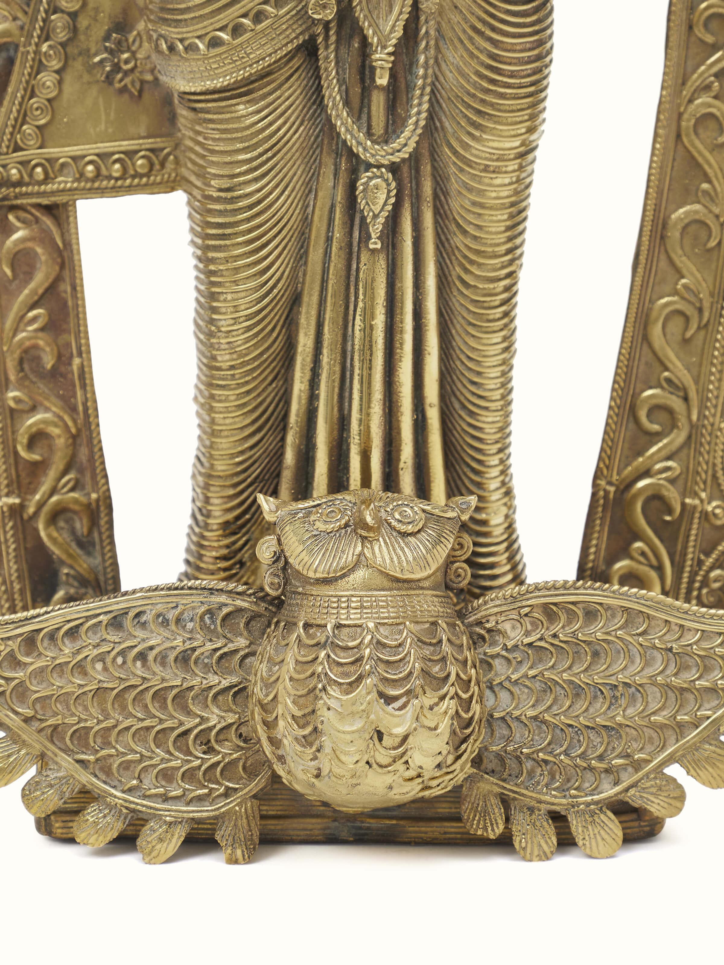 Close-up view of Vasudha dhokra brass Lakshmi idol, focusing on the intricate details.