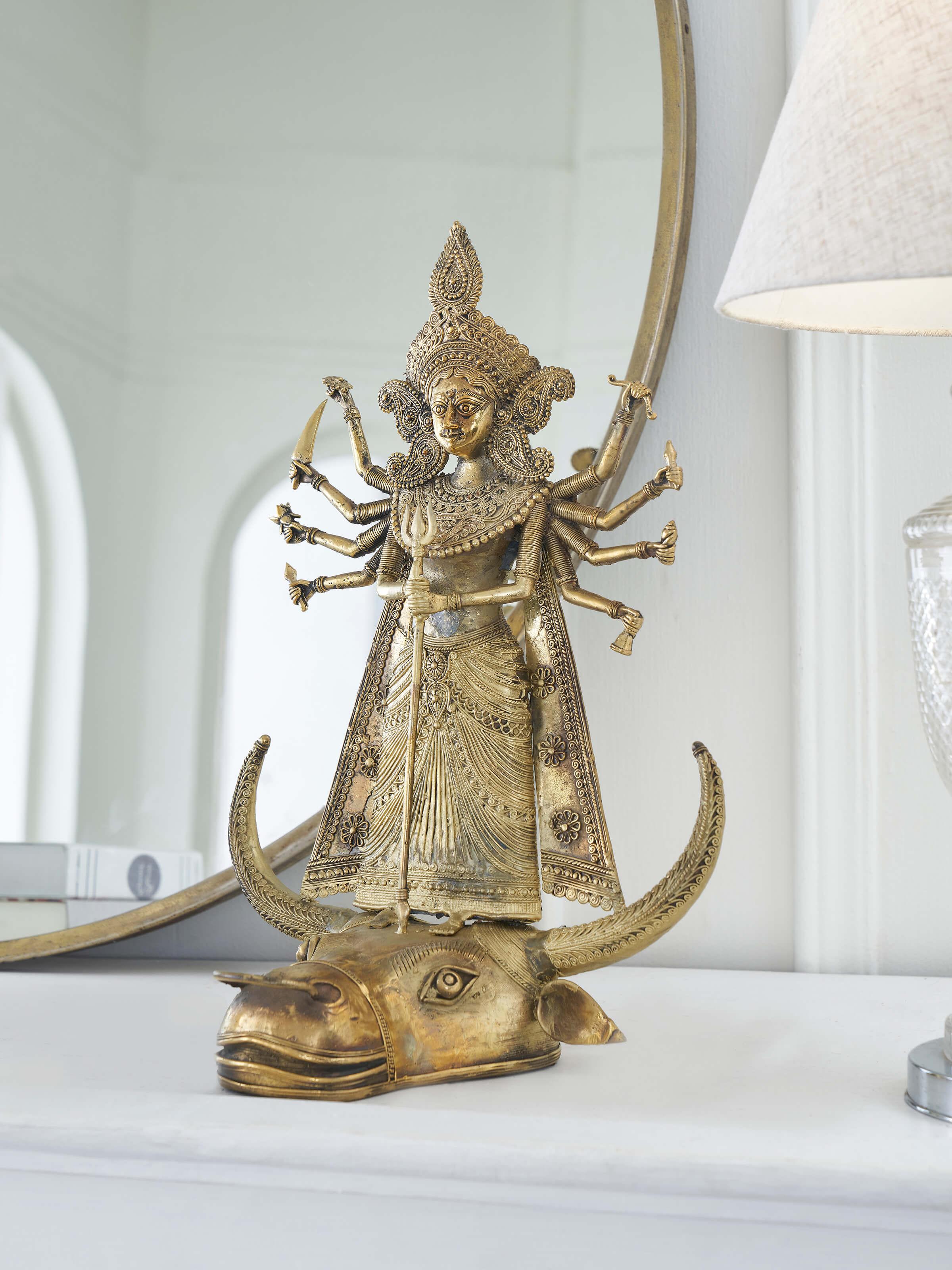 Side view of Brass dhokra Durga on bull idol in golden color highlighting intricate details and elegant finish.