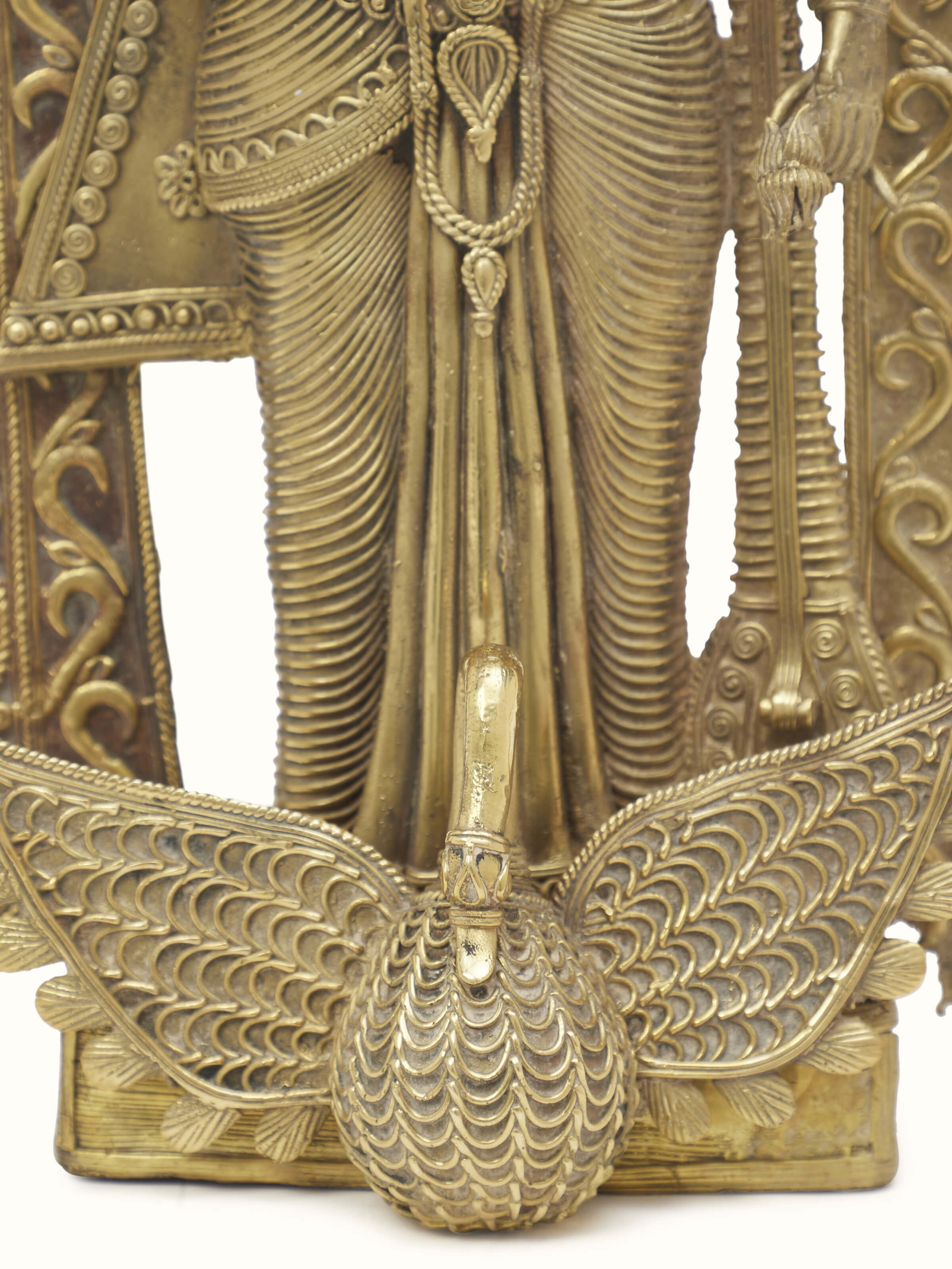 Side view of Vishnupatni dhokra brass Lakshmi on conch shell idol showcasing artistic design