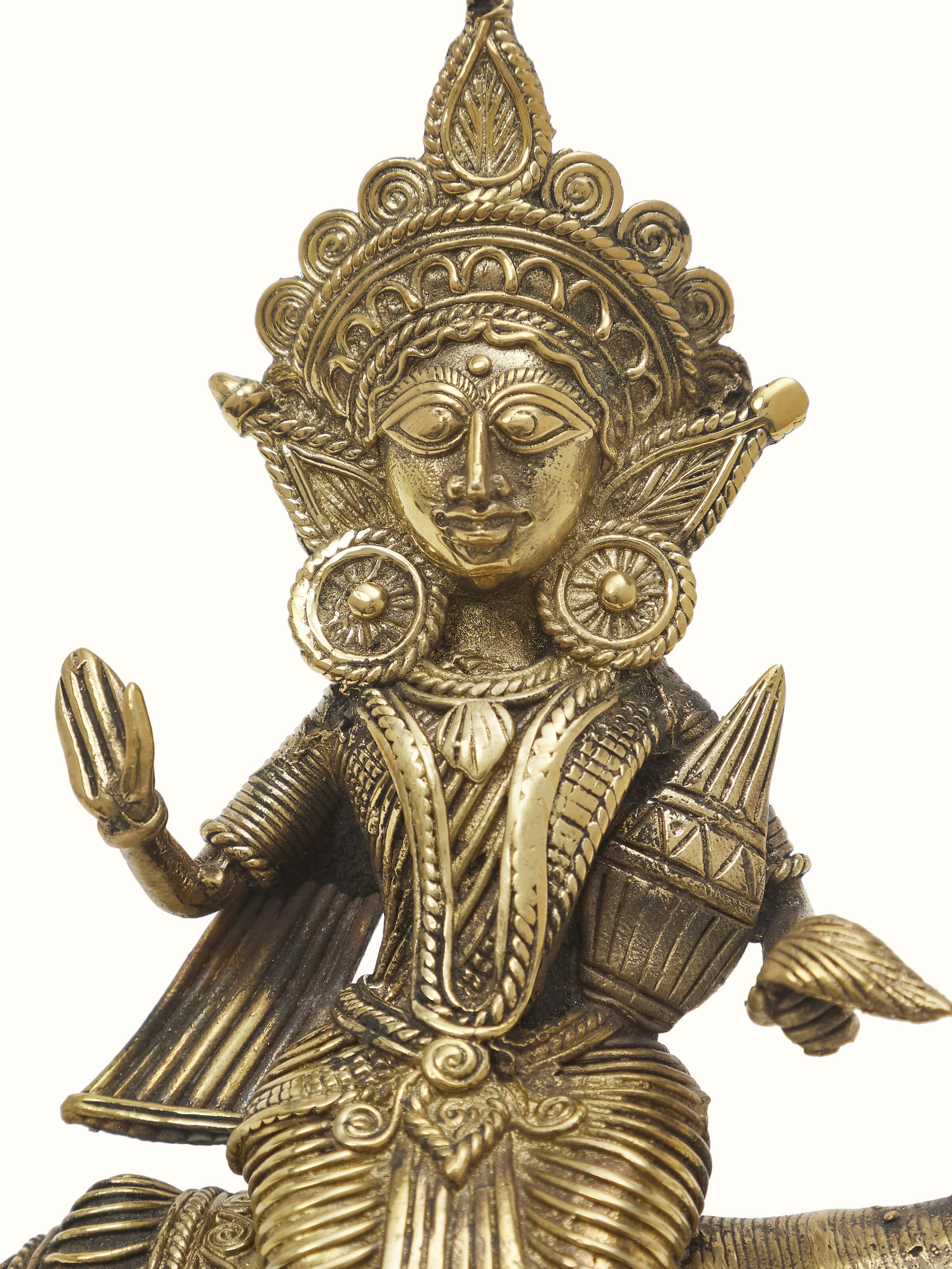Angled view of Vishnupatni dhokra brass Lakshmi on conch shell idol with decorative features