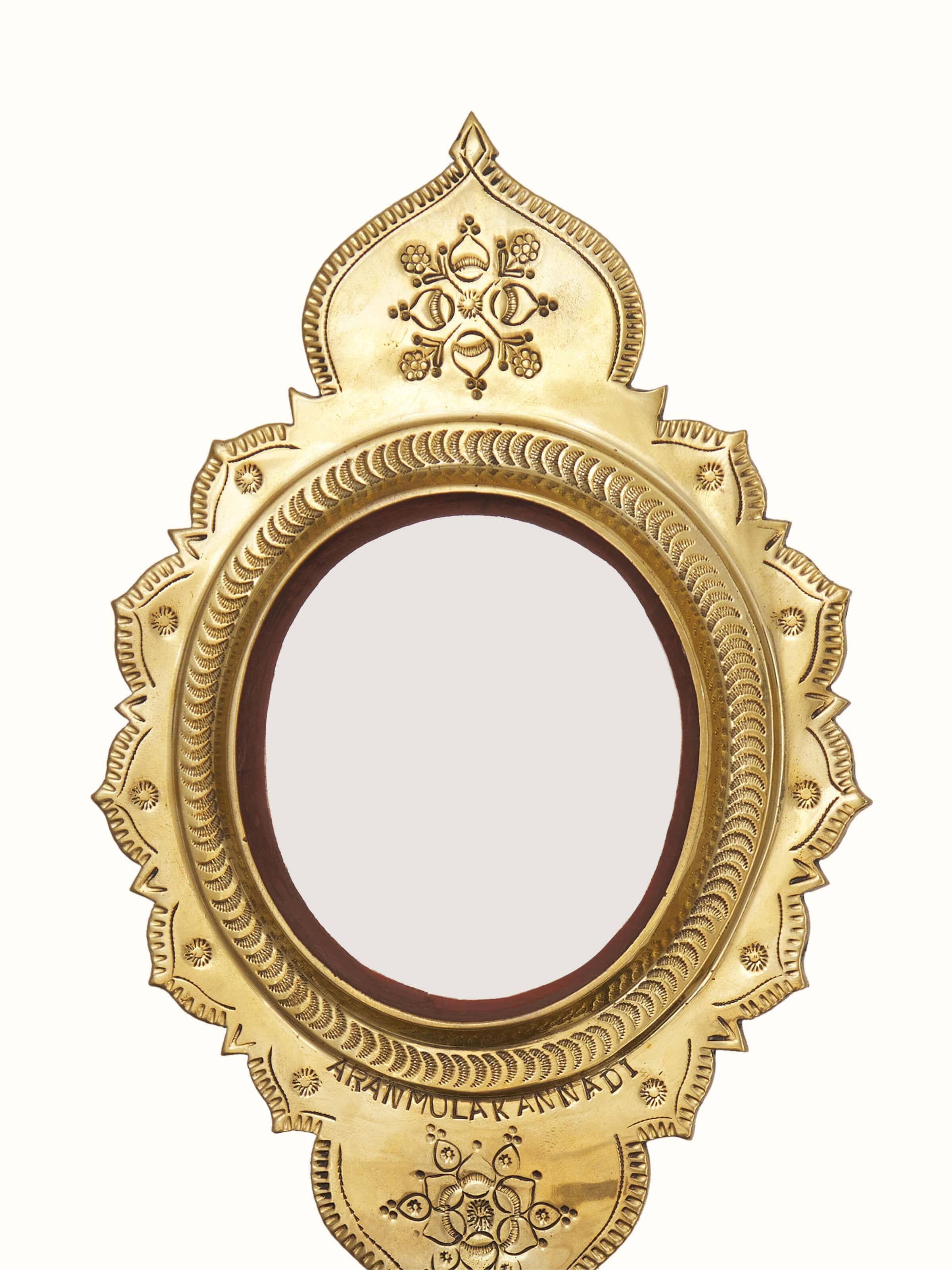 Detailed close-up of Transitional Aranmula Kannadi brass mirror showing the fine brass detailing and craftsmanship