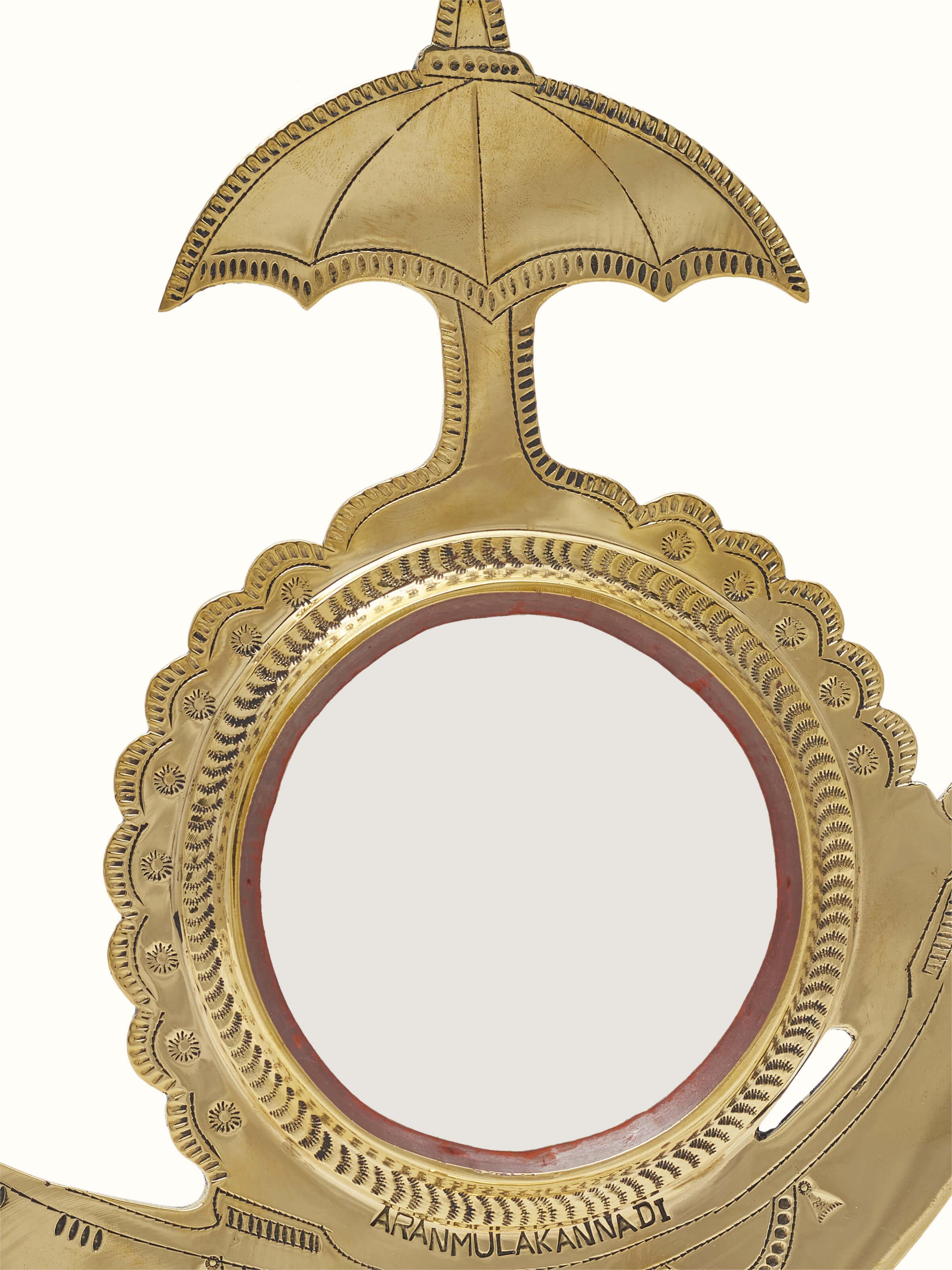 Detailed view of Aranmula Kannadi Brass Mirror highlighting the brass frame design