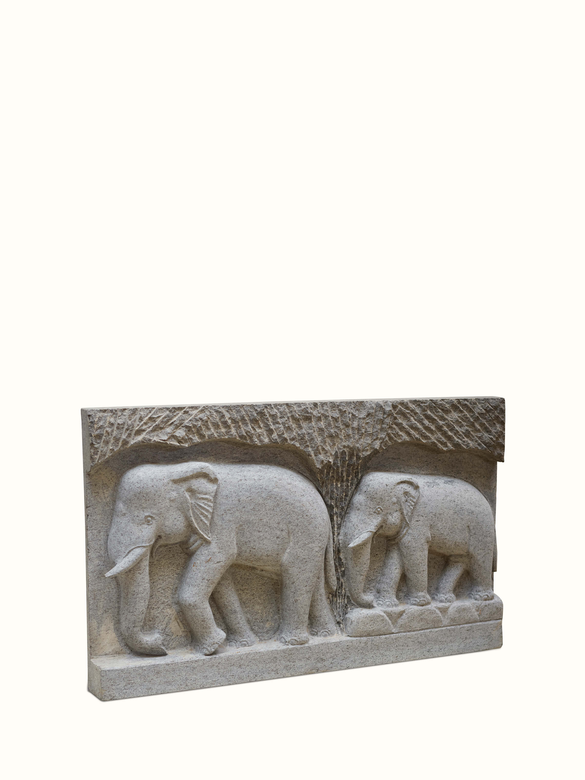 Angled view of Magnificent carved stone elephant panel sculpture highlighting the intricate stonework and design