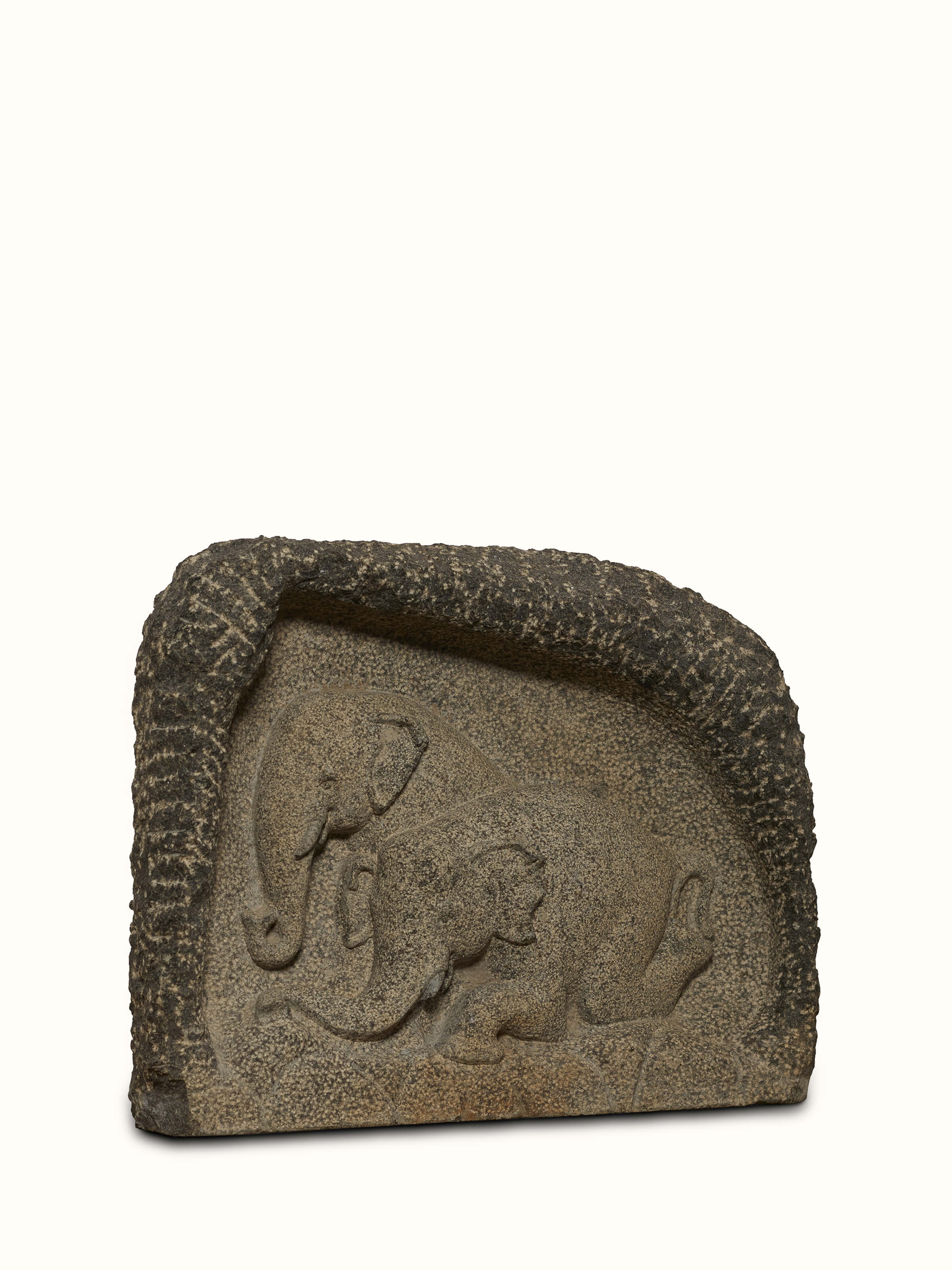 Side view of Adambara carved stone shore elephants sculpture emphasizing the craftsmanship and intricate details.