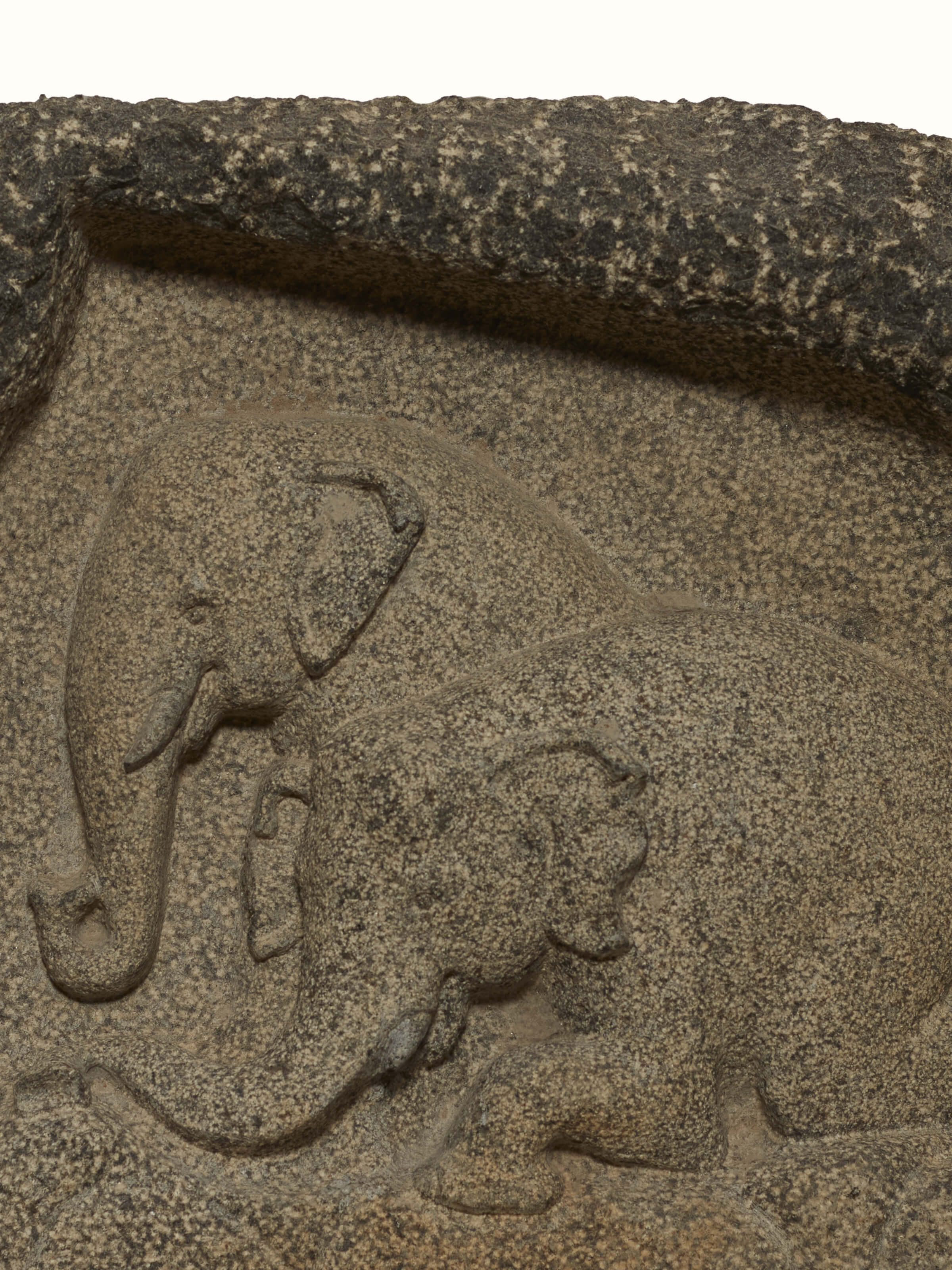 Angle view of Adambara carved stone shore elephants sculpture displaying its elegant design and carving.