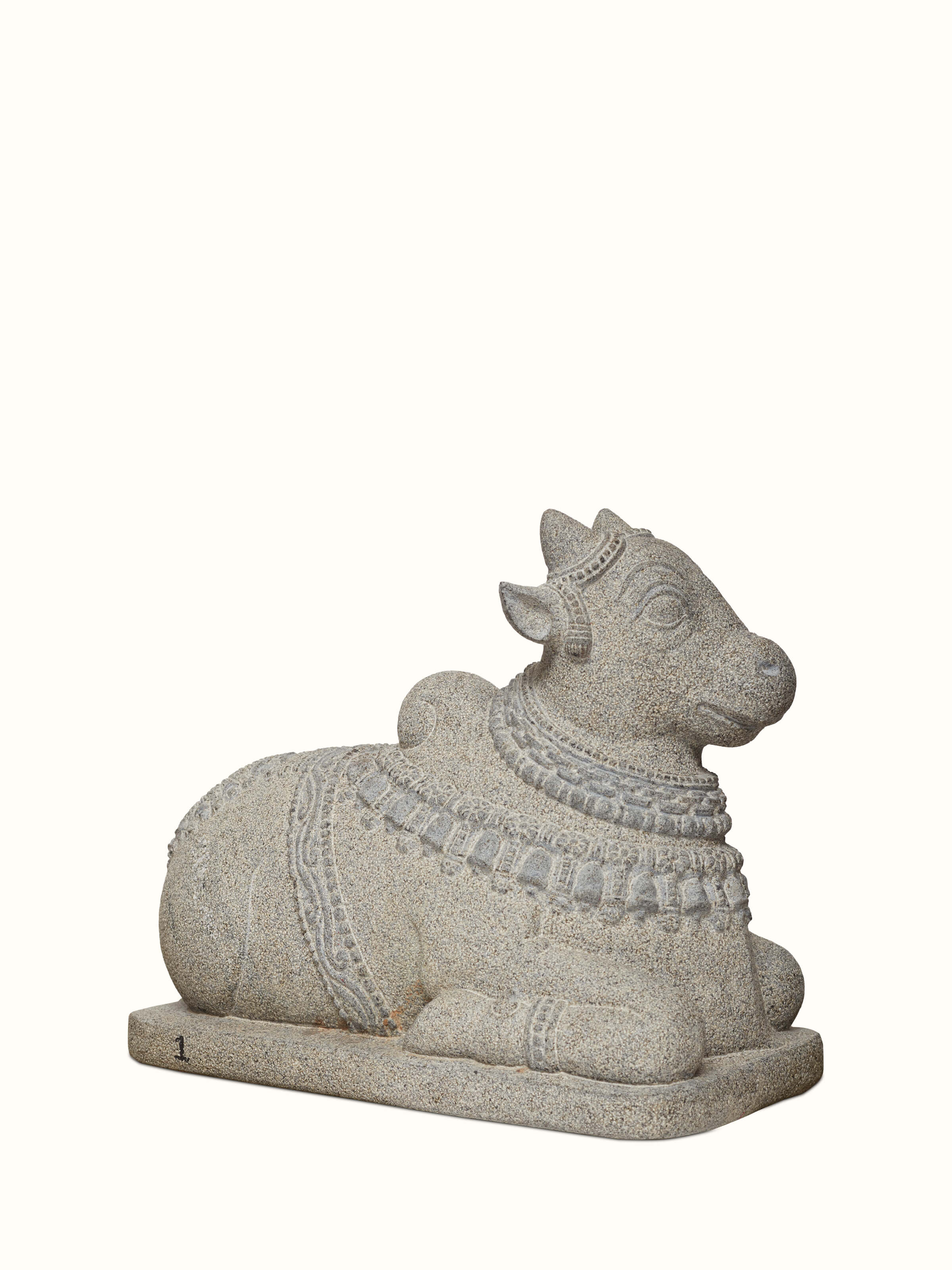Close-up of Majestique carved stone adi nandi sculpture focusing on detailed carvings and stone texture