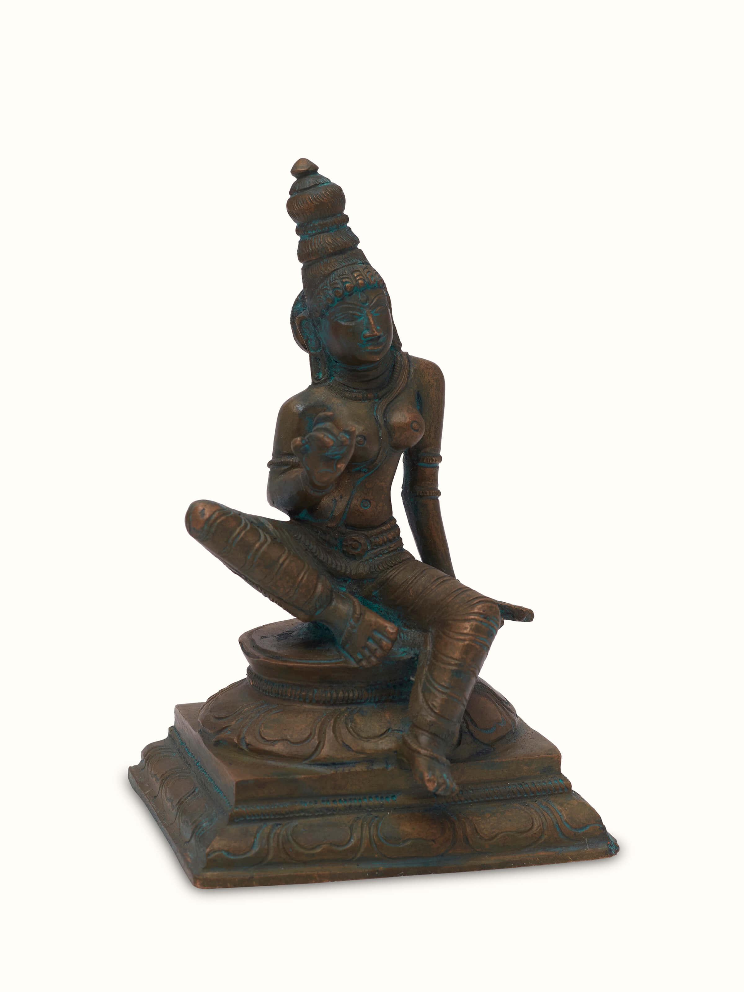 Close-up of antique bronze casting boga Sakthi idol, focusing on its artistic design
