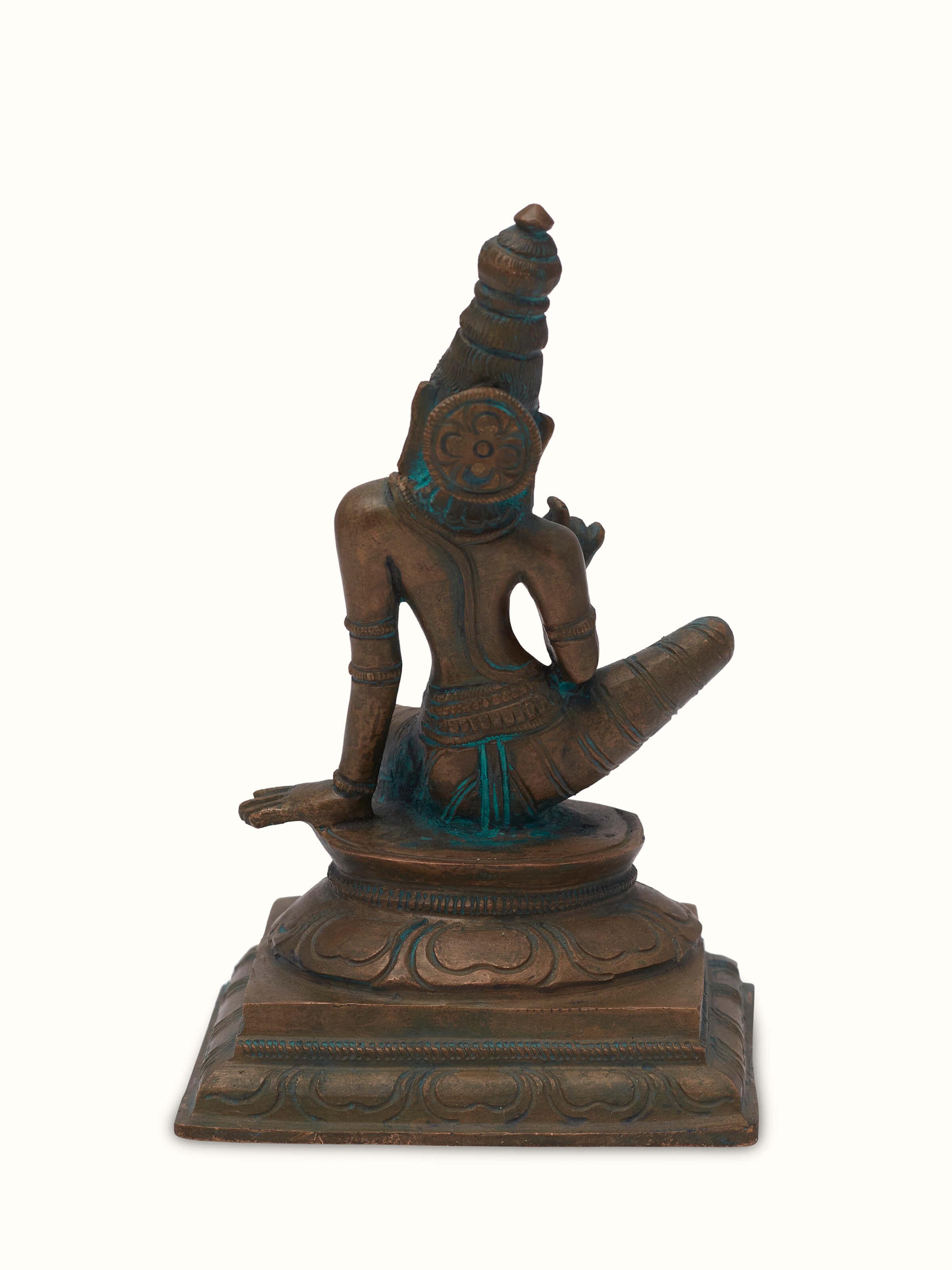 Angled view of antique bronze casting boga Sakthi idol, showcasing its ornate design