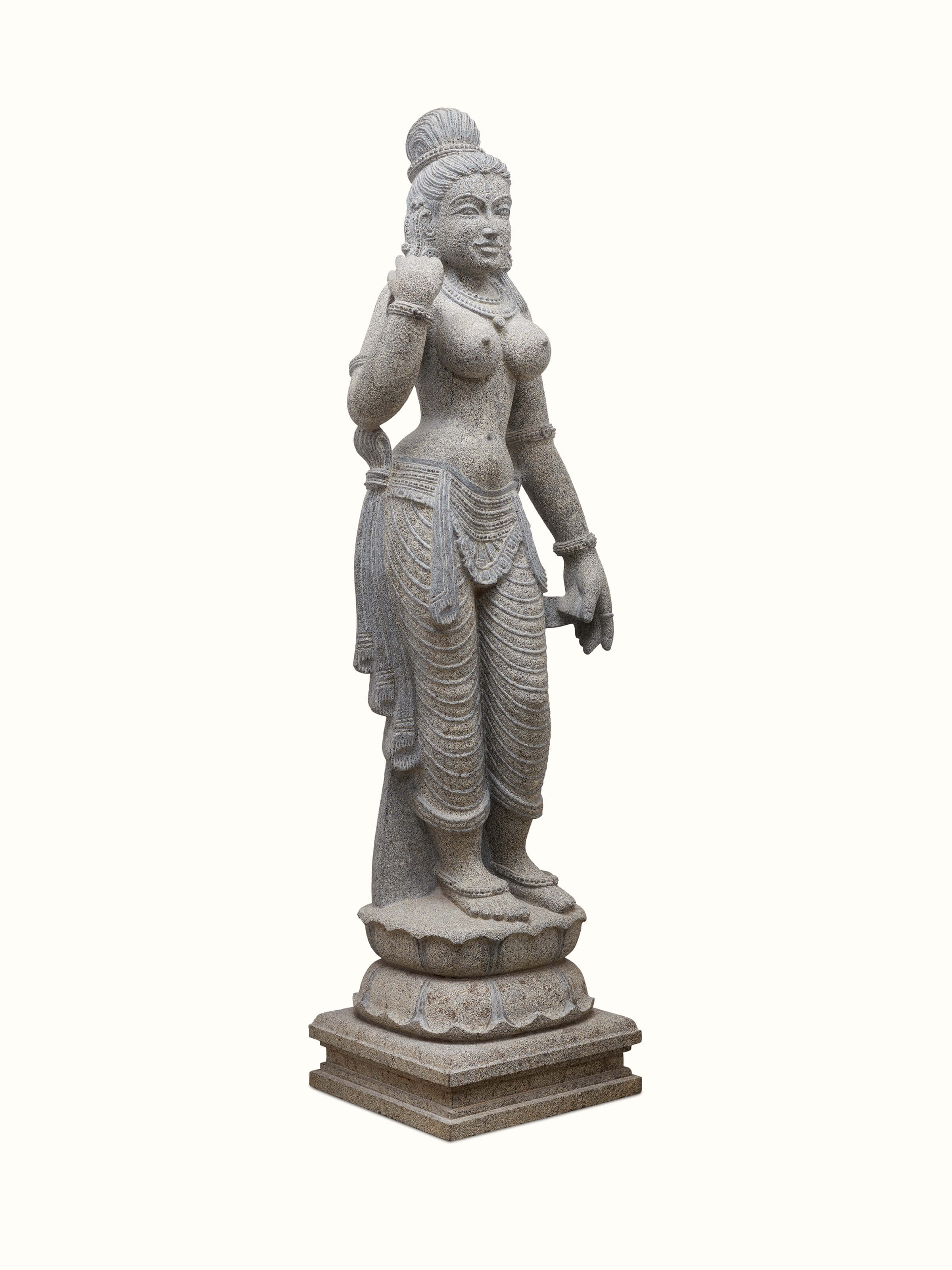 Angled view of Deviji Stone Idol, highlighting the intricate stone carving and traditional posture of the goddess.