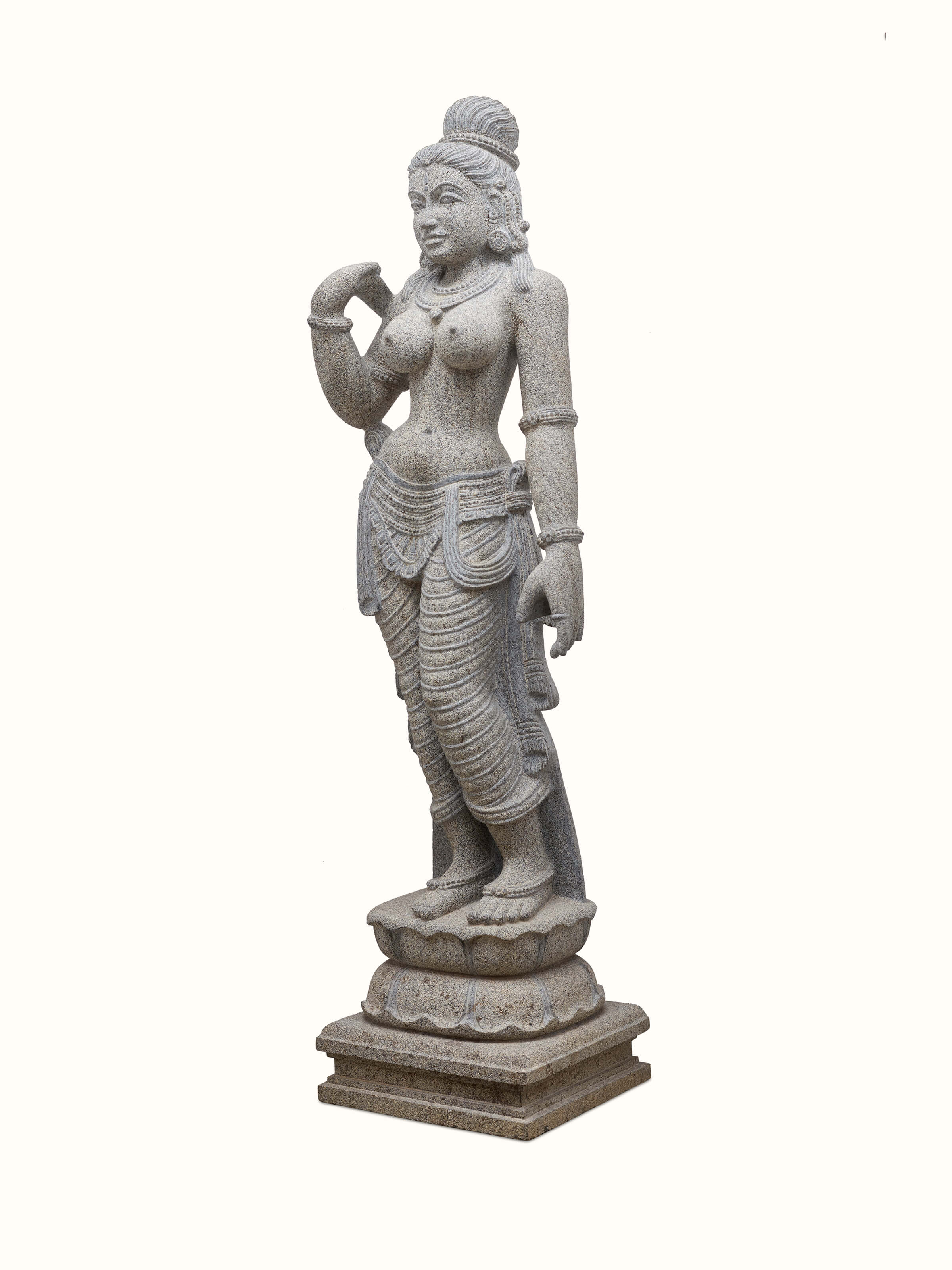 Side view of Stone Carved Deviji Idol, emphasizing the flowing contours and finely detailed ornamentation.