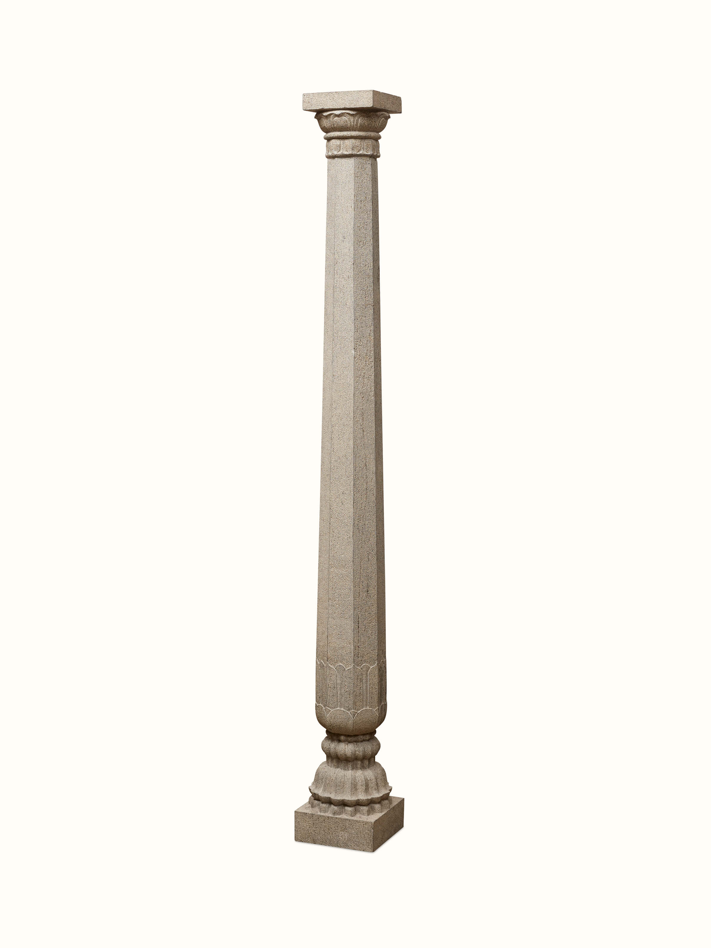 Side view of Prabal carved stone pillar sculpture highlighting the detailed carvings and artistic features