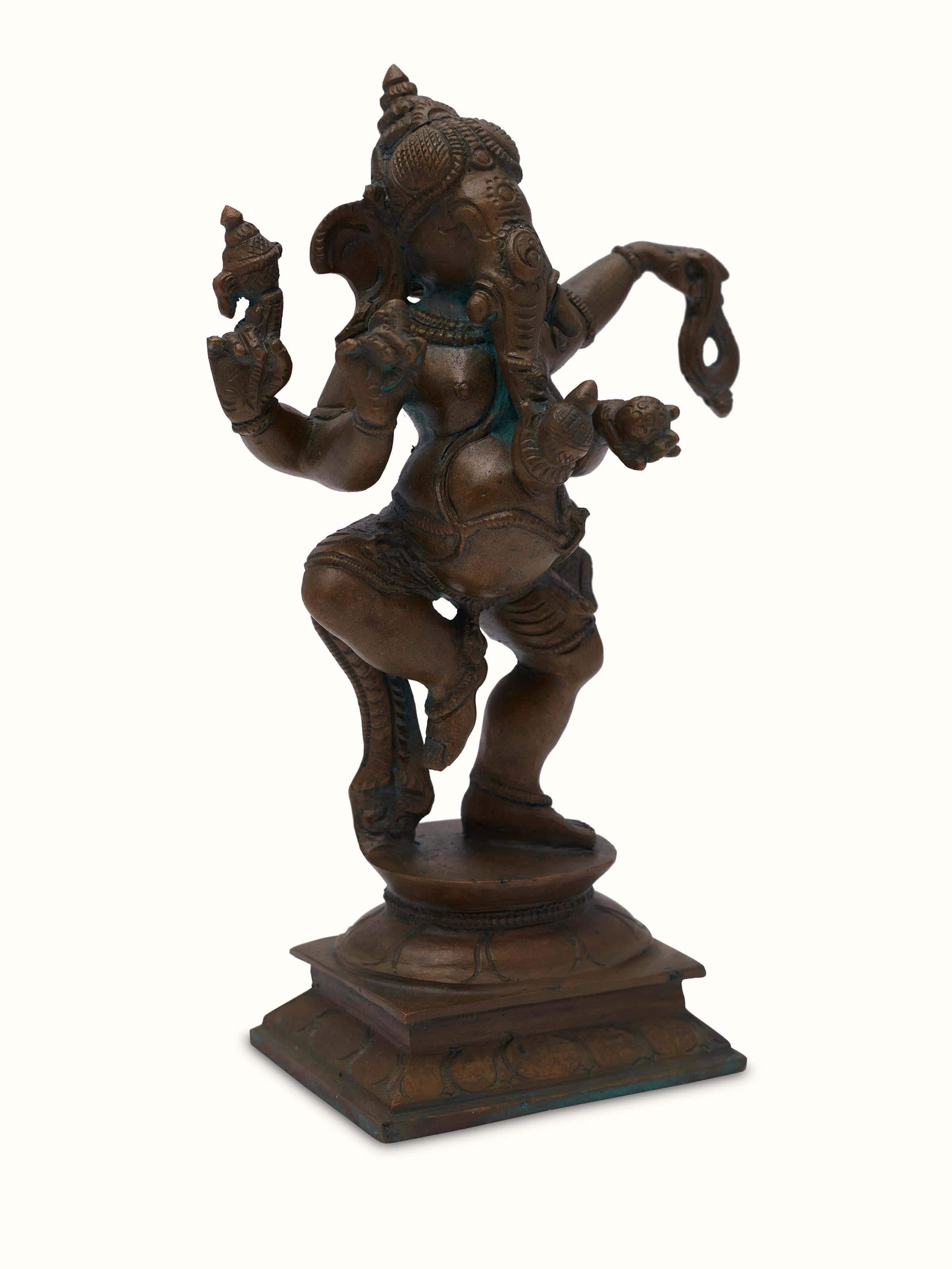 Side view of bronze casting dancing Ganesha idol highlighting the intricate details and bronze finish