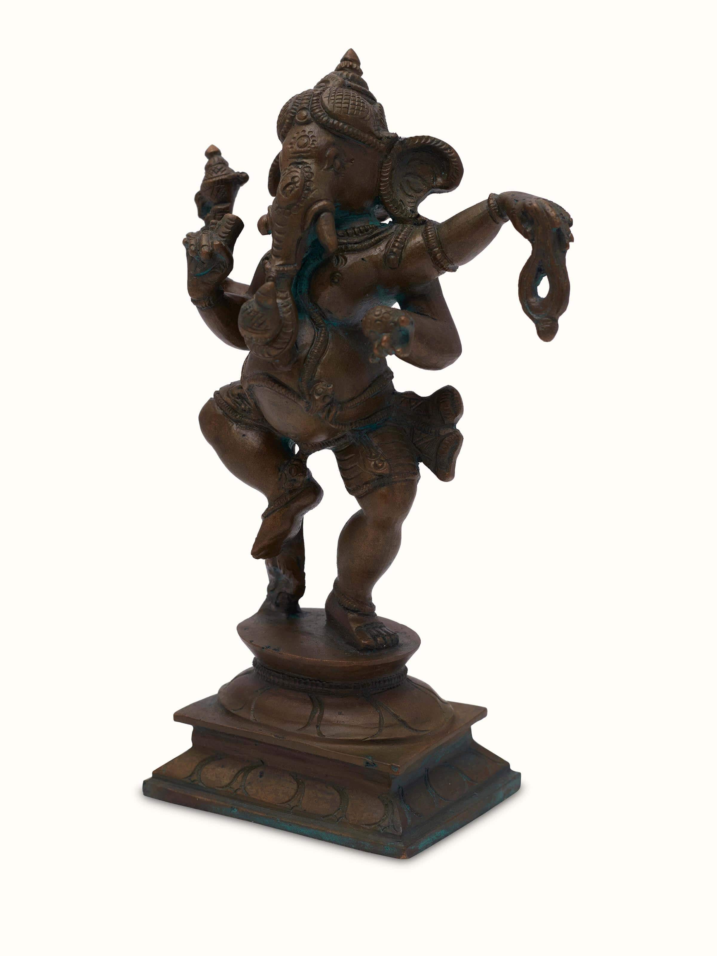 Close-up of bronze casting dancing Ganesha idol focusing on the fine detailing and artistic design