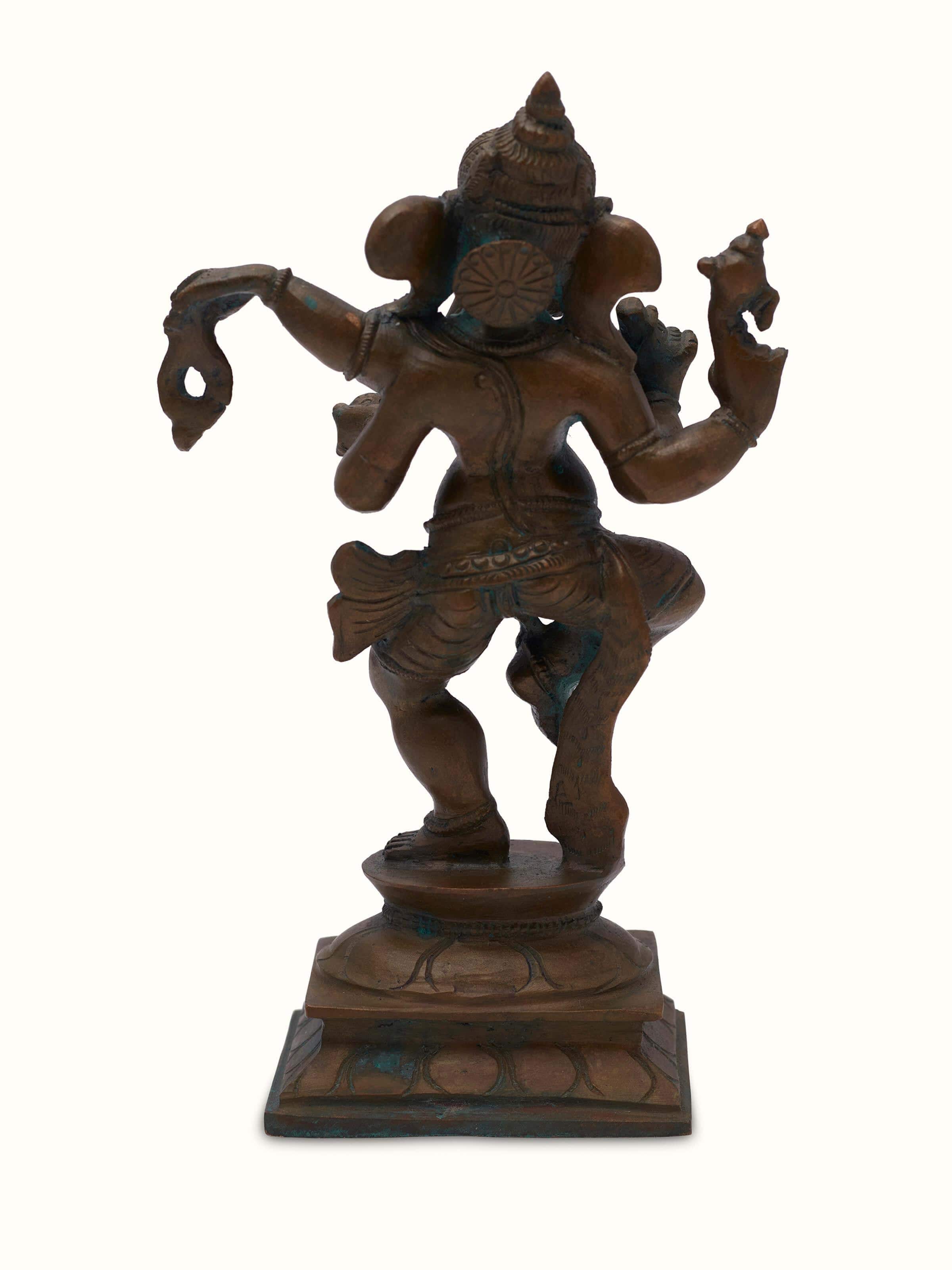 Detailed close-up of bronze casting dancing Ganesha idol highlighting its intricate features and bronze texture