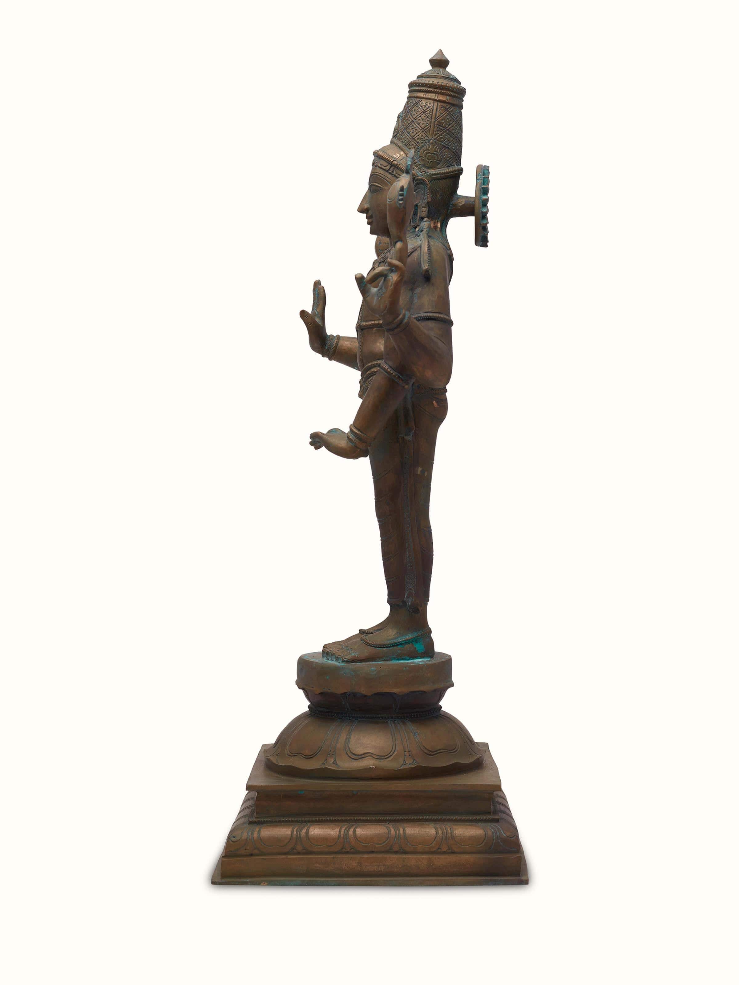 Angled view of Magnificent bronze casting Vishnu idol emphasizing ornate features