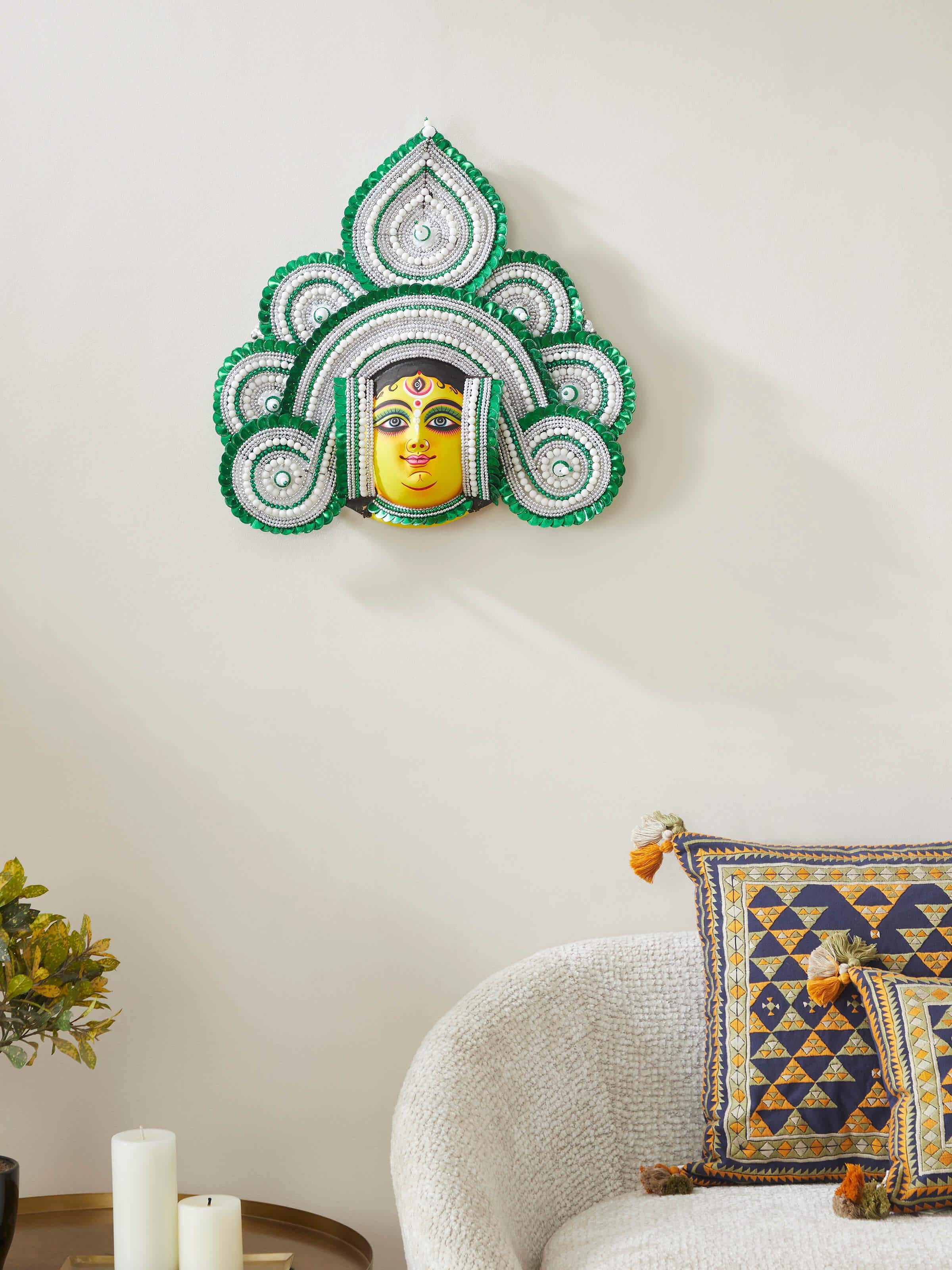 Side view of green chhau clay and paper goddess Durga wall mask focusing on intricate details.